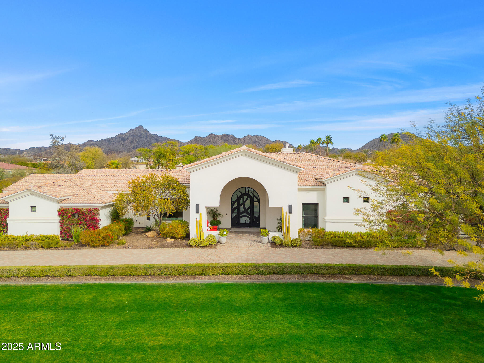 Picture perfect, turn key home with jaw dropping mountain scenery! Located in Paradise Valley and conveniently located close to the well known Biltmore, this recently renovated home is in a league of its own. Main house features 4 en-suite bedrooms plus a formal living and dining area, tall barrel ceiling in the family room, 10ft telescoping doors, designer finishes and so much more. Professional grade kitchen with oversized quartz waterfall island, Sub-Zero fridge/freezer, double ovens, 8 top gas burner Wolf range, spacious walk-in pantry and a temperature controlled wine display. The luxurious owner's suite boasts a charming sitting area with grand windows to capture the impeccable landscape and views. Spa-like bathroom with soaking tub, dual vanities, private water closet and a sophisticated walk-in clothing closet. Detached guest house wonderful for guests or a home office that boasts a full kitchen, bedroom, bathroom and living space. Soak up the sunshine all year long with this incredible backyard, diving pool, outdoor BBQ, ramada, large covered patio, basketball court and an upstairs viewing deck overlooking the entire Valley.