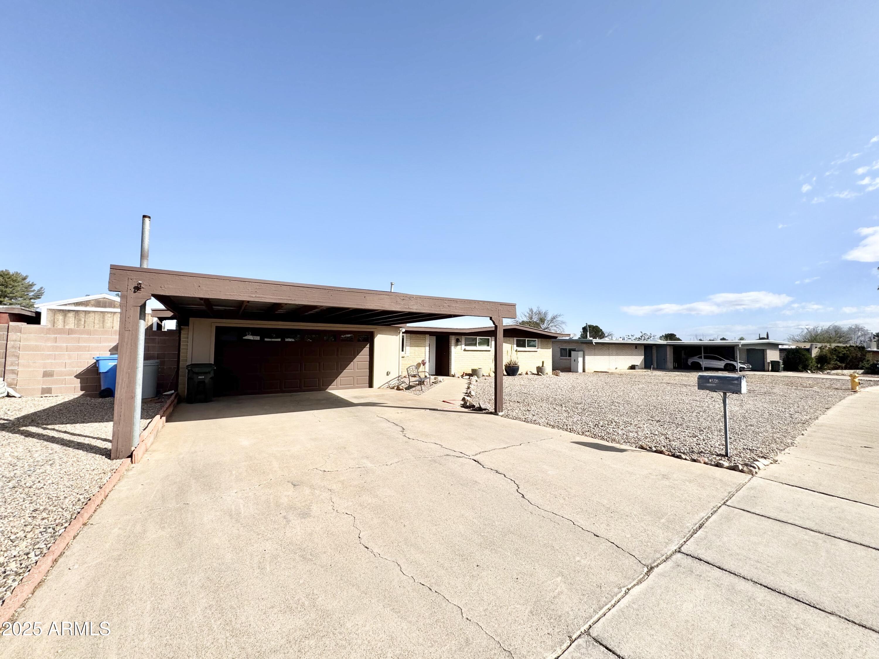 This beautifully maintained 3-bedroom, 2-bathroom home in Sierra Vista offers 1678 sq. ft. of thoughtfully designed living space. The galley-style kitchen is both stylish and functional, featuring soft-close cabinets and newer stainless steel appliances. The bathrooms boast elegant granite countertops, adding a touch of luxury. Meticulously cared for by its owners, the home includes a spacious 2-car garage, an additional 2-car carport, and an RV gate for added convenience. The backyard is a standout feature with two new sheds, perfect for extra storage or a workshop setup. With inviting living areas and a well-planned layout, this home is ideal for comfortable living. It also offers convenient access to local amenities, shopping, and dining.