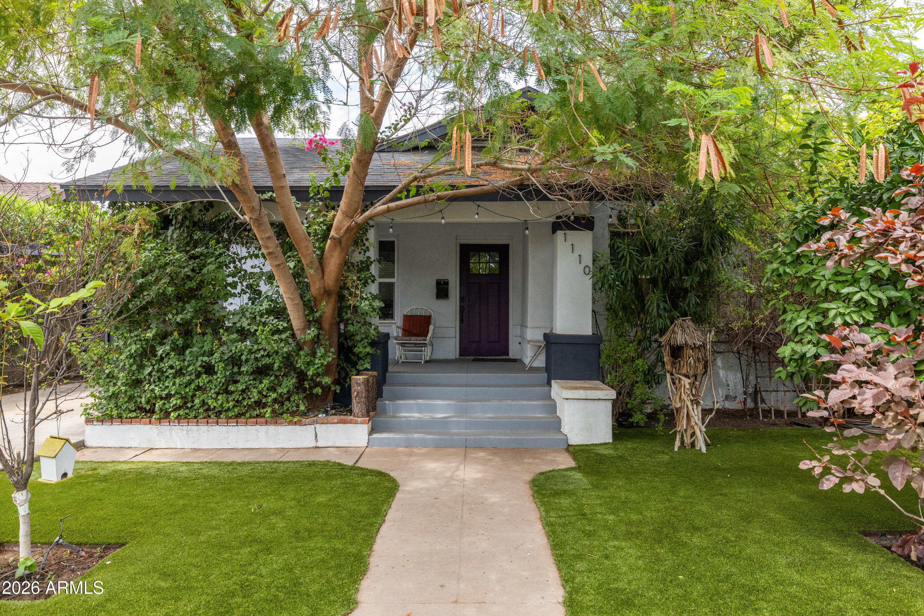 Completely remodeled from top to bottom, this triple income earning single family + guest house + finished basement historic bungalow is a rare and beautiful offering in the best part of Garfield Historic.  Well-located, walking distance to ASU Downtown, Gallo Blanco, and Roosevelt Arts District, this special gem features a 1,700+ sf 3 bedroom, 2 bath main home, a finished basement of over 220 sf with its own dedicated entrance and exit, and a fully permitted detached, 2 BEDROOM guest house of 660sf, all surrounded by lush mature landscaping, on an excellent block. The main home's features, inside and out, include a outdoor deck, and BBQ area, a coveted and charming conversation front porch typical of all craftsman bungalows of this age and era, lush private yard with custom perimeter fence, 1 extended covered parking space, low maintenance LPV flooring throughout, upgraded lighting and plumbing fixtures, vaulted ceilings, upgraded insulation, exposed brick accent walls, dual pane windows, upgraded cabinetry, floating shelving, quartz countertops with waterfall edge, upgraded hardware and appliances, split primary suite for added privacy, coffee station with accent wallpaper, washer, dryer, and fridge (all convey), large primary bedroom, with en-suite bath, large walk-in closet, and private rear patio access, upgraded paneled doors, floor to ceiling marble tile in the luxury level en-suite bath, dual sinks, walk in shower, separate soaking tub, generously sized secondary bedrooms, charming upgrades and details in the guest bath, interior laundry, and loads of storage. The finished basement features a kitchenette, bath, and bedroom space, and the detached permitted guest house features rear alley entrance, papered driveway and patio area, dedicated off-street parking, and is new construction from top to bottom. Don't miss this incredibly rare property in the heart of the best part of Garfield Historic, an area that just keeps improving in access to shopping, services, restaurants, bike paths, public parks, public transportation, pride of ownership, and demand!