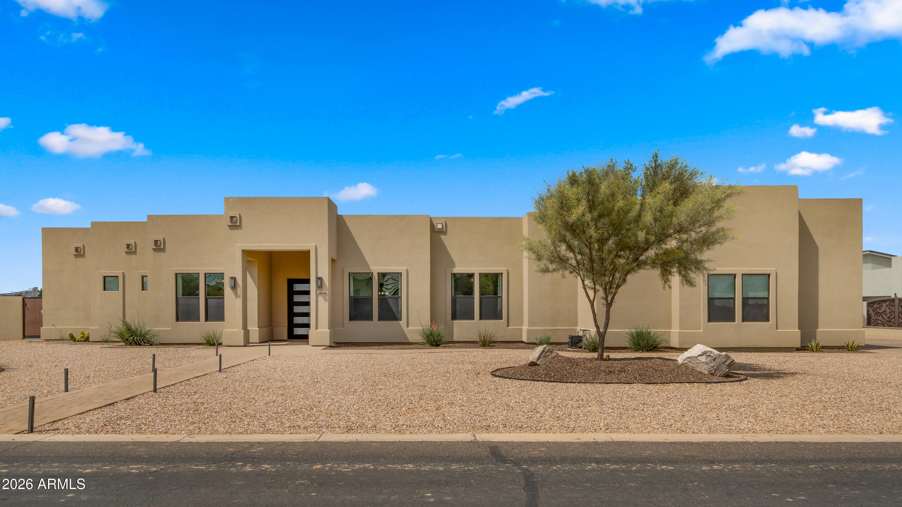 Discover a rare opportunity to own a custom home in an intimate, gated enclave of just 12 exclusive residences in the heart of Queen Creek.

Set on over an acre within the highly sought-after Chandler Unified School District, this home offers a lifestyle that's becoming increasingly hard to find--space, privacy, and a true sense of calm, all just minutes from everyday conveniences.

Surrounded by the natural beauty of the San Tan Mountains, the area invites you to enjoy the outdoors, from scenic trails to breathtaking desert sunsets. Nearby, Horseshoe Park & Equestrian Centre hosts year-round events, markets, and community gatherings--adding energy and connection to everyday life. And just a short drive away, the vibrant Pecan Lake Entertainment District offers a growing mix of dining, boutique shopping, and local hotspots--making it easy to enjoy a night out or a relaxed weekend close to home.

With polished exposed concrete flooring for a contemporary edge, the home has been thoughtfully refreshed with newly painted interiors and a professionally epoxied garage floor, creating a clean, move-in-ready feel. A well-designed split floor plan offers flexibility and comfort, with spaces that adapt to how you live.
Step outside to a sprawling backyard designed for both relaxation and possibility--lush grass, an oversized covered patio, and room to expand with a future casita, custom garage, or whatever your lifestyle calls for.

Homes in communities like this--where privacy, location, and lifestyle align--are exceptionally rare.