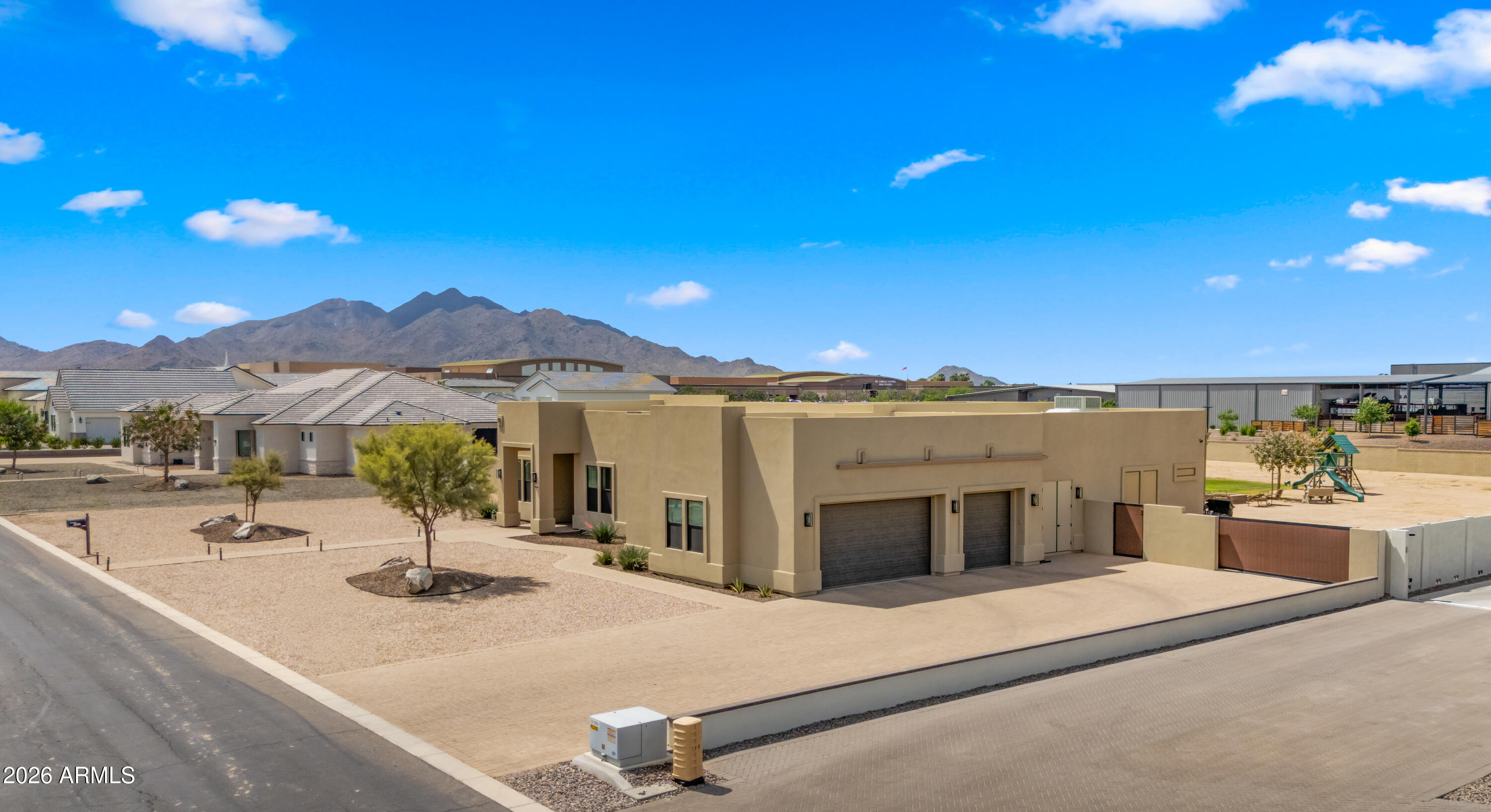 Discover a rare opportunity to own a custom home in an intimate, gated enclave of just 12 exclusive residences in the heart of Queen Creek.

Set on over an acre within the highly sought-after Chandler Unified School District, this home offers a lifestyle that's becoming increasingly hard to find--space, privacy, and a true sense of calm, all just minutes from everyday conveniences.

Surrounded by the natural beauty of the San Tan Mountains, the area invites you to enjoy the outdoors, from scenic trails to breathtaking desert sunsets. Nearby, Horseshoe Park & Equestrian Centre hosts year-round events, markets, and community gatherings--adding energy and connection to everyday life. And just a short drive away, the vibrant Pecan Lake Entertainment District offers a growing mix of dining, boutique shopping, and local hotspots--making it easy to enjoy a night out or a relaxed weekend close to home.

With polished exposed concrete flooring for a contemporary edge, the home has been thoughtfully refreshed with newly painted interiors and a professionally epoxied garage floor, creating a clean, move-in-ready feel. A well-designed split floor plan offers flexibility and comfort, with spaces that adapt to how you live.
Step outside to a sprawling backyard designed for both relaxation and possibility--lush grass, an oversized covered patio, and room to expand with a future casita, custom garage, or whatever your lifestyle calls for.

Homes in communities like this--where privacy, location, and lifestyle align--are exceptionally rare.