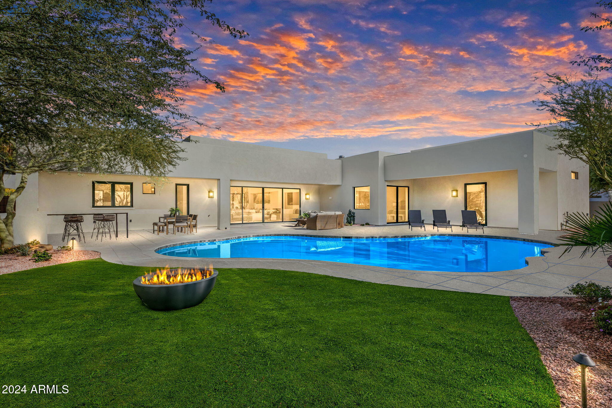 2024 EXTENSIVE RENOVATION! This elegant property blends modern luxury with thoughtful design, offering seamless indoor-outdoor living in a prime location.

The front courtyard welcomes you with charm and privacy, leading to an expansive open-plan interior. The gourmet kitchen, equipped with Miele appliances, features a gas stove, steam oven, and 60'' refrigerator-freezer. Quartz countertops and sleek finishes make it a chef's dream. Adjacent, the dining and family room centers around a gas fireplace, with pocket sliding doors opening to the backyard. A spacious great room includes a wet bar, wine and beverage refrigerators, and flexible seating for entertaining. Throughout the home, natural light and exquisite fixtures elevate every space.
The principal suite is a private retreat, complete with a fireplace, pool views, and a luxurious en suite bathroom featuring a glass shower, soaking tub, dual sinks, and a walk-in closet. Two guest en suites also include walk-in closets, while the separate guest casita offers three bedrooms, two bathrooms, a kitchenette, a living room and a laundry roomperfect for extended stays or private living quarters.

Outdoors, the vast backyard impresses with a sparkling pool, multiple seating areas, a built-in BBQ, firepit, synthetic grass and bar seating for entertaining. Sustainability features include Tesla-owned solar panels with a 6.75 KW inverter supporting the entire home, plus a three-car garage pre-wired for EV chargers.

This extraordinary home combines unparalleled comfort with cutting-edge amenities, setting a new standard for luxury living.