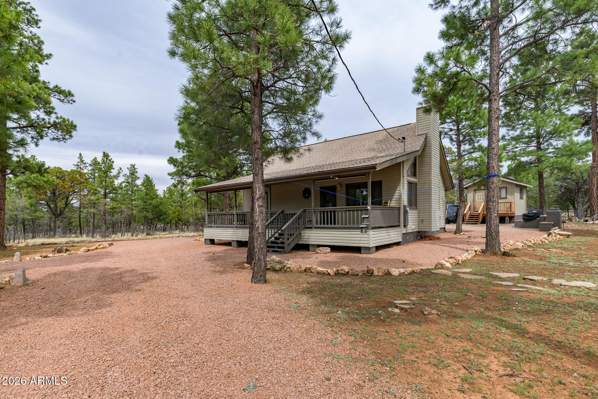 Discover your dream retreat in Happy Jack, AZ! This charming cabin spans 1,472 sq. ft. and is nestled on 1.5 acres of lush, towering pines, offering a serene escape from everyday life. The well-maintained home features fresh new carpet and a spacious new deck, perfect for enjoying the tranquil surroundings. With a cozy atmosphere and ample natural light, this cabin is an ideal getaway for families or nature lovers. Plus, a 350 sq. ft. bunkhouse provides extra space for guests or storage. Embrace outdoor adventures, explore nearby trails, or simply unwind in this picturesque setting. Don't miss the chance to own this unique slice of paradise!