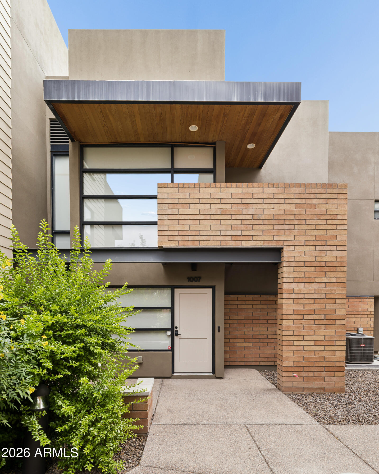 Rare find! Contemporary townhome in the heart of Tempe. Floor-to-ceiling windows, skylights, luxury vinyl flooring throughout, split-level floorplan & two-car garage. Recent major upgrades include a new A/C unit (2023), LVP flooring (2024), exterior paint (2024), & front door (2025). This thoughtfully designed home offers a versatile lower level with a bedroom, full bath, private enclosed patio, & den/office. Upstairs, you'll find an expansive living area with a walkout balcony, open-concept kitchen & dining, a second bedroom with walk-in closet, bathroom with double-vanity, & laundry area. Conveniently located less than 2 miles from ASU, Whole Foods & Tempe Town Lake. Easy access to the Valley Metro Rail System & Sky Harbor Airport. Don't miss this one!
