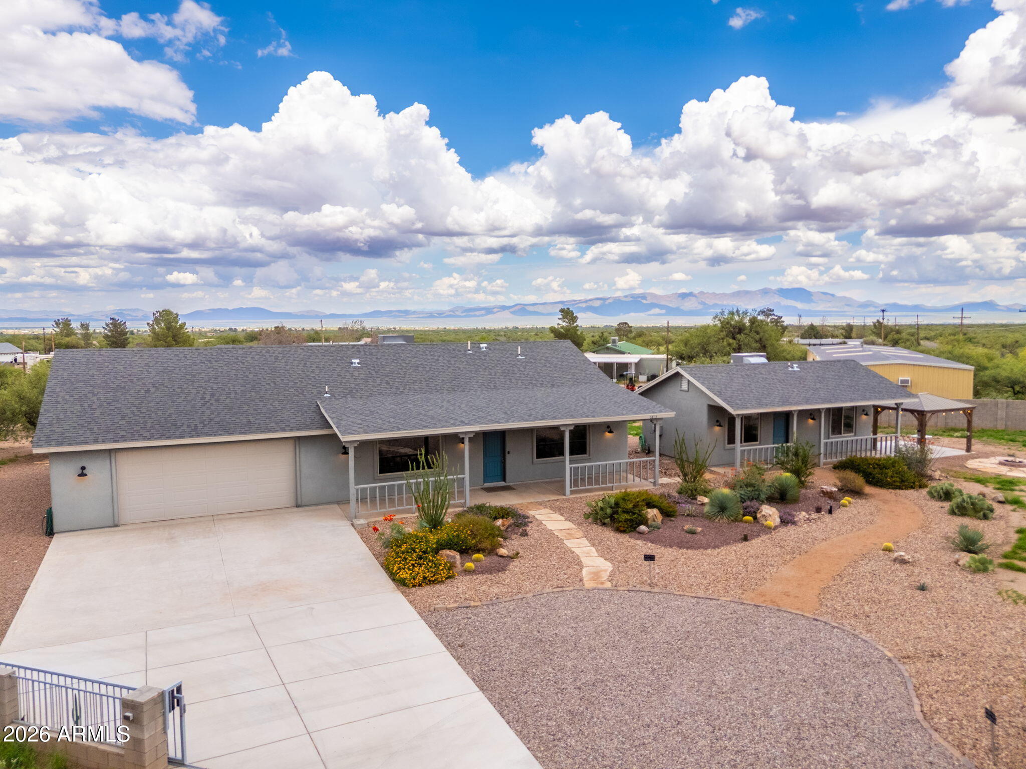 Discover exceptional Southern Arizona living with this custom-built estate featuring a separate guest house, thoughtfully designed for multi-generational living or guests. The main house offers 2 bedrooms, a dedicated office, and 2 baths, complemented by a stunning gourmet kitchen. Guest house offers 1 bedroom, 1 bath, full kitchen, and laundry. 

Step outside to enjoy expansive covered patios, 2 gazebos, 2 fire pits, and a built-in BBQ, creating the ultimate outdoor gathering space. Additional custom touches continue with a whole-house generator, full RV hookups with both 30 & 50 amp service, a pull-through garage, and a fully fenced parcel with gated entry.

Easy access off of paved roads and surrounded by breathtaking mountain views, this one-of-a-kind property is a showstopper!