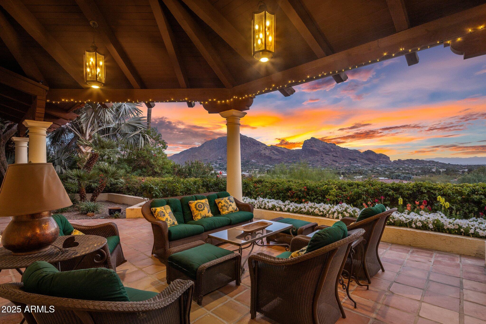 Step into this private retreat, perched on one of the highest lots on Mummy Mountain, and take in breathtaking, bird's-eye views of the valley. This stunning estate offers ultimate privacy, enhanced by meticulously curated landscaping that creates a true oasis. Enjoy uninterrupted, panoramic vistas of Camelback Mountain, stretching all the way to the twinkling city lights of Downtown Phoenix. Start your morning with coffee on one of four patios, and end the day by one of four fireplaces, admiring the spectacular Paradise Valley sunsets. The home's thoughtful layout includes five ensuite bedrooms and a split floor plan, with the primary suite extending the full length of the home. Whether you envision modern elegance or wish to preserve its timeless charm, this home is the perfect canvas to create the sanctuary of your dreams.