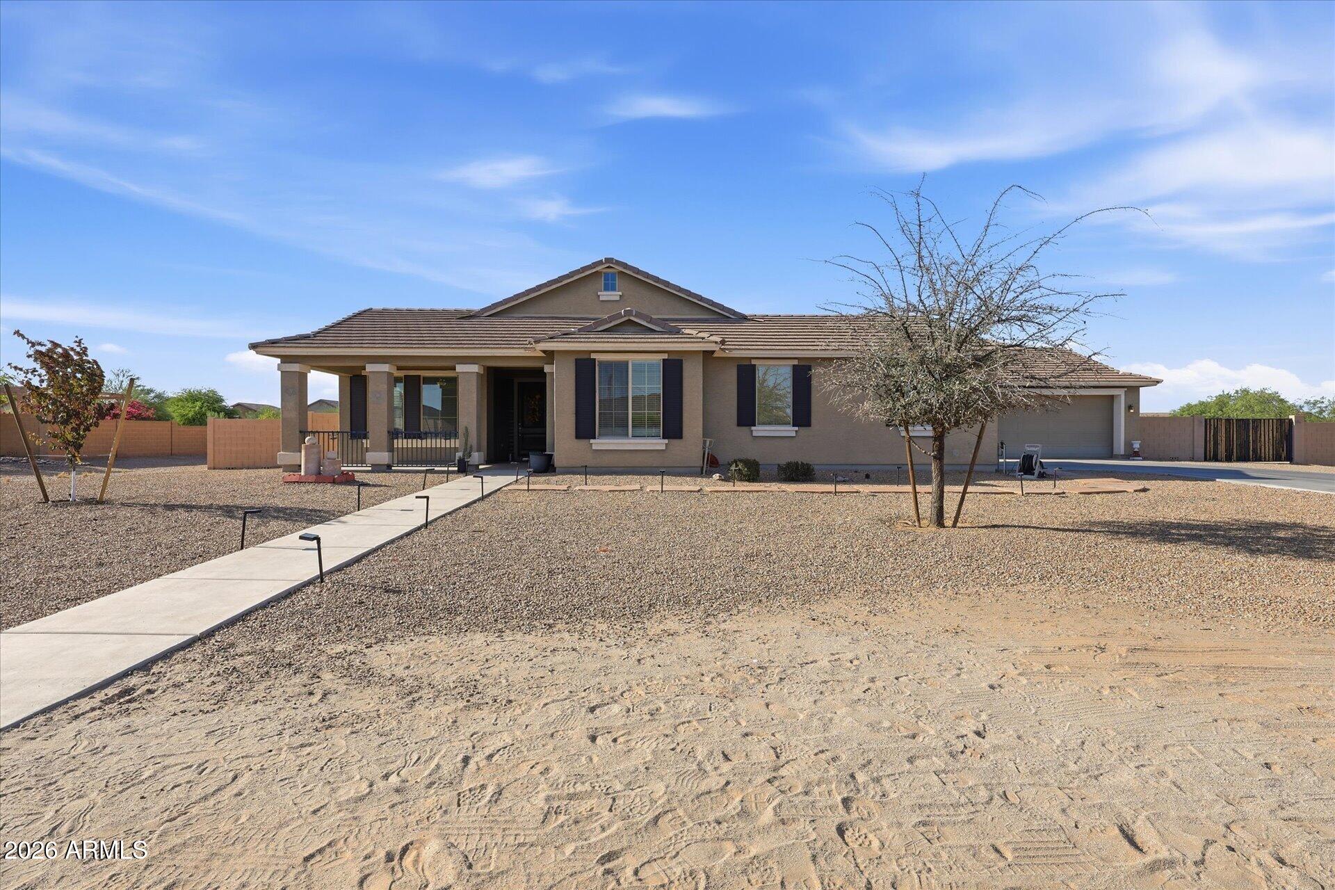 Assumable 2.875% interest rate! Semi-custom home in Queen Creek on a one-acre premium lot with stunning mountain views at an unbelievable price. TWO SEPARATE 2-car garages plus a guest casita with private entrance, spacious bedroom, and full bath -- ideal for multi-family living or rental income.  Four bedrooms plus a private office that easily converts to a fifth. Beautiful wood-like tile floors and a master closet that will knock your socks off. The fully fenced backyard features a built-in fire pit, ramada-covered pool table area, swing space, and a 12x24 storage shed perfect as a workshop. Expansive yard has room for a pool, garden, or playground. RV gate with actual RV parking.  Minutes from San Tan Regional Park, golf, healthcare, and Queen Creek's newest shopping and dining.