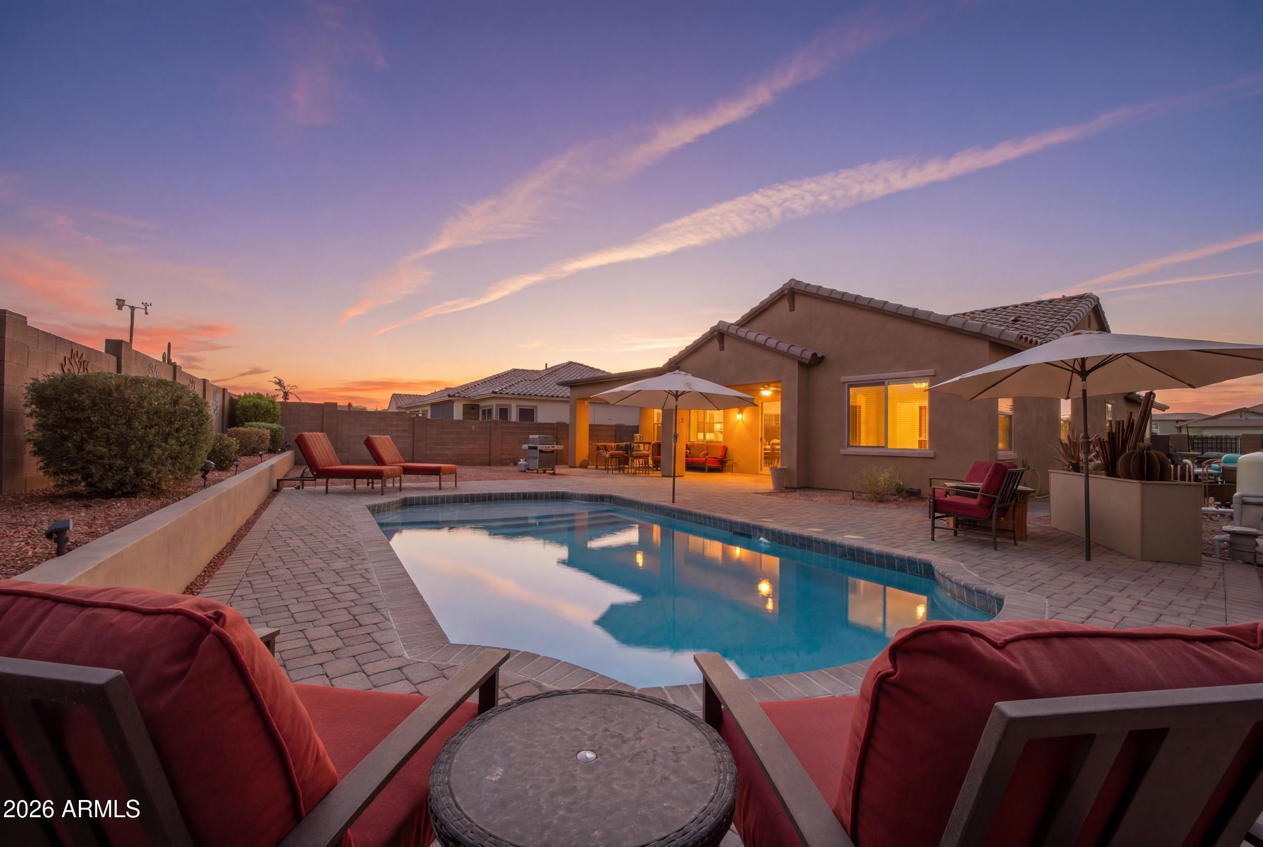 Welcome to Estrella Mountain Ranch! This beautifully maintained single-level home offers an open-concept floor plan with spacious living areas, abundant natural light, and seamless indoor/outdoor living. The private backyard features a sparkling pool, perfect for enjoying Arizona's year-round sunshine. Recent updates provide peace of mind, including new exterior paint (2025), a beautifully updated primary bathroom (2025), new A/C, and a new pool pump and filter (2026). Partial solar is owned outright, helping reduce energy costs. Enjoy all that Estrella has to offer, including lakes, hiking and biking trails, golf, parks, community pools, fitness centers, dining, and top-rated schools. Move-in ready and waiting for you!
