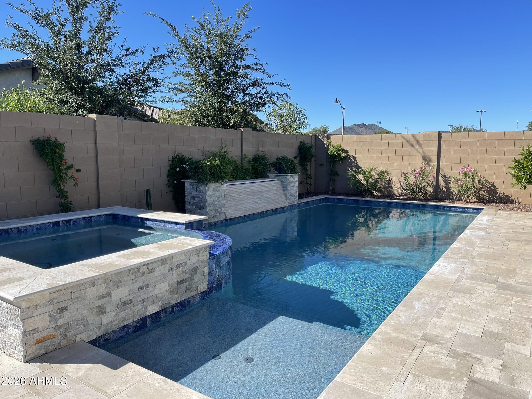 Experience resort-style living in the prestigious master-planned community of Verrado! This stunning 4-bedroom single story home features your own private pool & hot tub -- perfect for Arizona living. This home is currently furnished and can be rented furnished as well. Verrado is more than a neighborhood; it's a lifestyle. Enjoy the benefits of the A' rated Litchfield School District, boutique shopping, acclaimed restaurants, championship golf, and vibrant entertainment, all just minutes away. Tree-lined streets, community parks, and a small-town charm make this one of the West Valley's most sought-after addresses. Whether you're relaxing poolside or exploring everything Verrado has to offer, this home delivers the perfect blend of comfort and community.