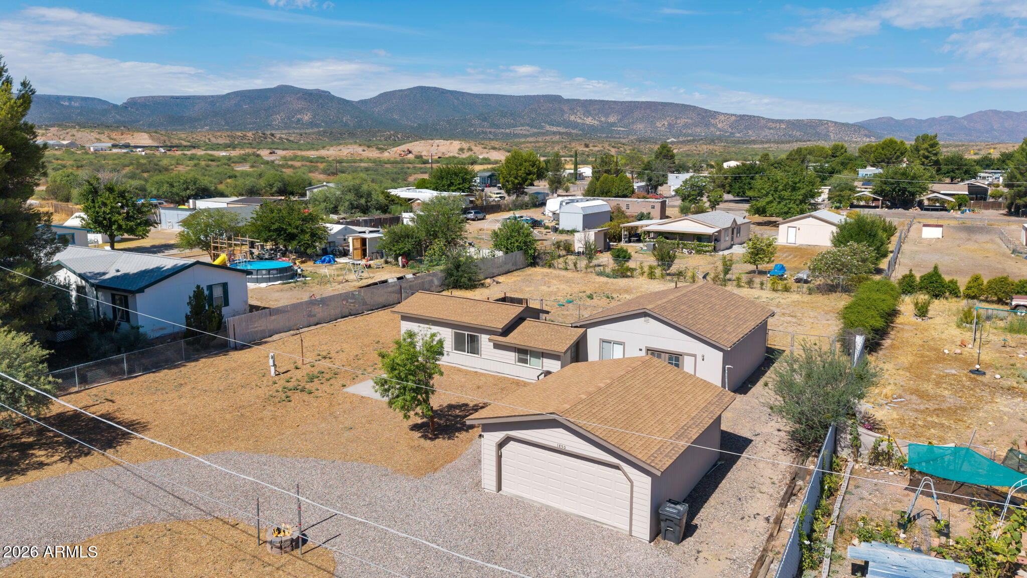 A proven investment opportunity in the heart of Camp Verde! Situated on a spacious 0.43-acre lot, this versatile property features two well-appointed living units, offering excellent income potential. The main home is a comfortable one-bedroom, one-bath 720-square-foot residence featuring a cozy pellet stove, beautifully tiled shower, and a private fenced backyard with its own dog run. The attached casita is a thoughtfully designed 578-square-foot studio complete with a kitchenette, sleeping area, full bath, and an oversized walk-in closet. Each unit enjoys its own energy-efficient mini-split heating and cooling system, along with a dedicated stackable washer and dryer for added convenience. In addition, a large two-car detached garage provides additional storage or parking.... while the generous lot offers room for future possibilities. Whether you're looking to expand your investment portfolio or offset your mortgage by generating rental income, this property offers flexibility, functionality, and outstanding potential. Listing agent is a member of the LLC.