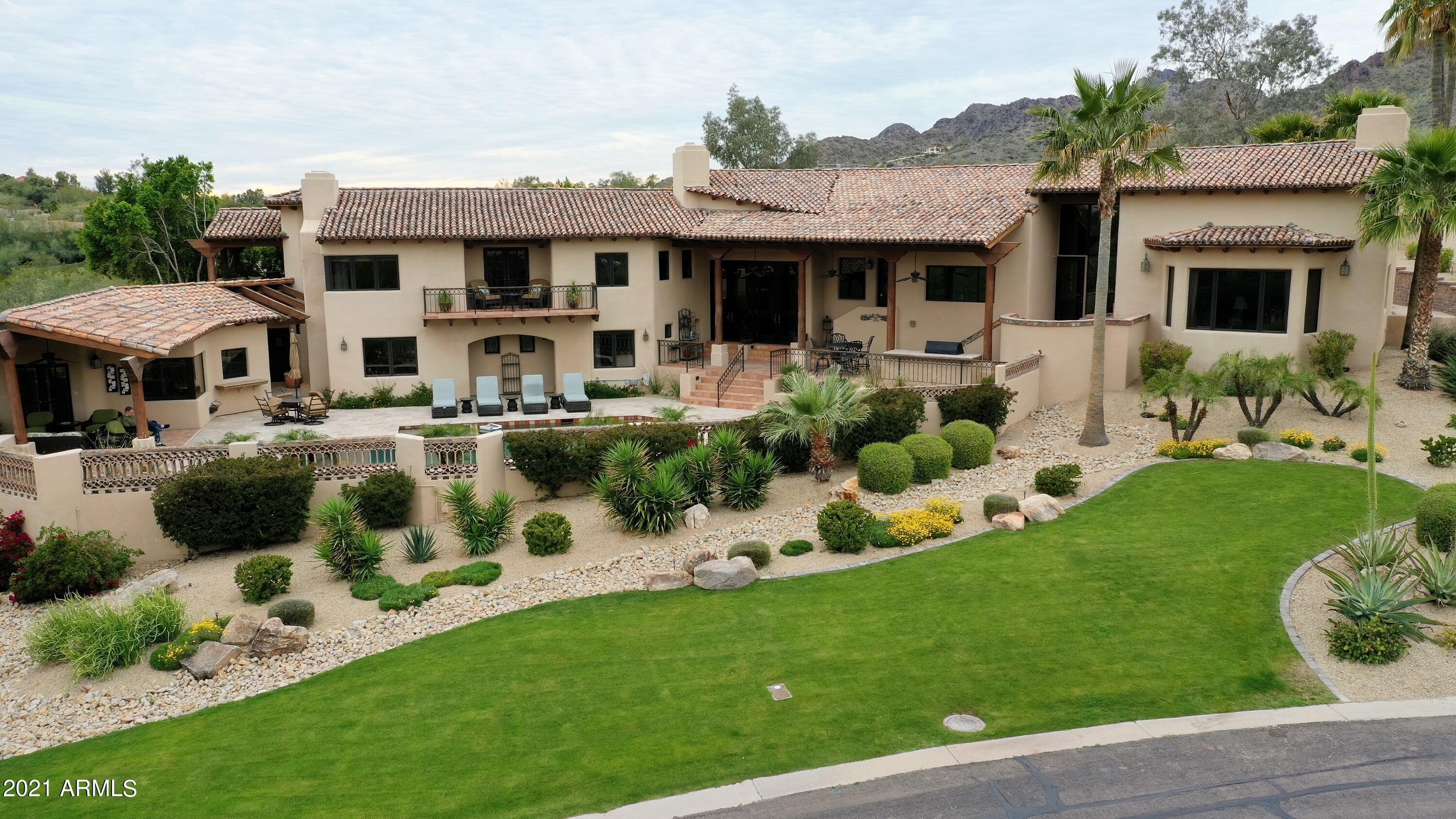 As you enter this Spanish Revival home, designed by George Christensen, you are drawn in by the expanse of the soaring ceilings, but also charmed by the warmth and character of exposed wood, arched windows, and wrought iron details and pottery accents, along with beautifully designed fountains, fireplaces, courtyards, covered patios, that offer panoramic views of Camelback & Mummy Mountain and Piestewa Peak.  
Situated hillside is the gated community of Clearview, its asymmetric facade, typical of Spanish Revival, creates a unique living and entertaining space that wraps around the pool and ramada and offers a different Camelback Mountain ''light show'' every night. Classic Spanish Revival terra cotta privacy walls create textured interest and openness, while providing privacy...MORE ...around the pool and front entry courtyard. 
The 5 bedroom, 4 ½ baths and spacious formal and informal areas provide plenty of space for family and fun. A charming, yet functional, casita and separate Sport Court that backs to a private wash, round out the entertainment options which include the renovated kitchen and bar. 
Wonderfully updated and maintained, this home serves as everything from a peaceful sanctuary, a family home, a setting for wonderful gatherings or a welcome retreat for overnight guests.
