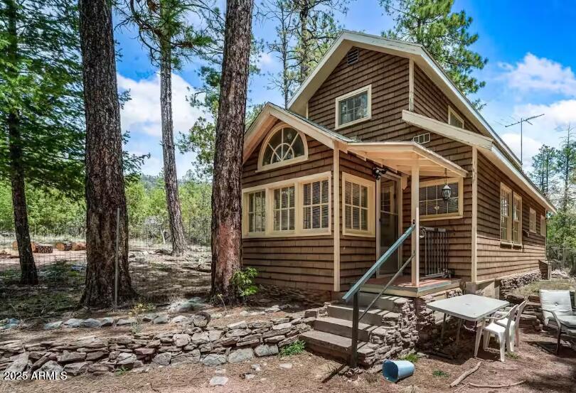 Situated on a large lot with room to build more; and Tucked into a quiet stand of pines near Payson, this inviting cabin is everything you want from a mountain getaway: warm, bright and effortlessly comfortable. The living area offers a classic wood-fired stove that fills the room with glow and crackle on cool evenings. Large windows wrap the main living spaces, bringing the forest inside with the views changing with every season.

The full kitchen is thoughtfully equipped for family meals and holiday feasts, with ample counter space and storage so cooking is a pleasure. A full bathroom is convenient and clean, and a washer and dryer make longer stays easy. The cabin's layout is spacious enough for board games, movie nights & family/friend gatherings. Firepit and storage/workshop