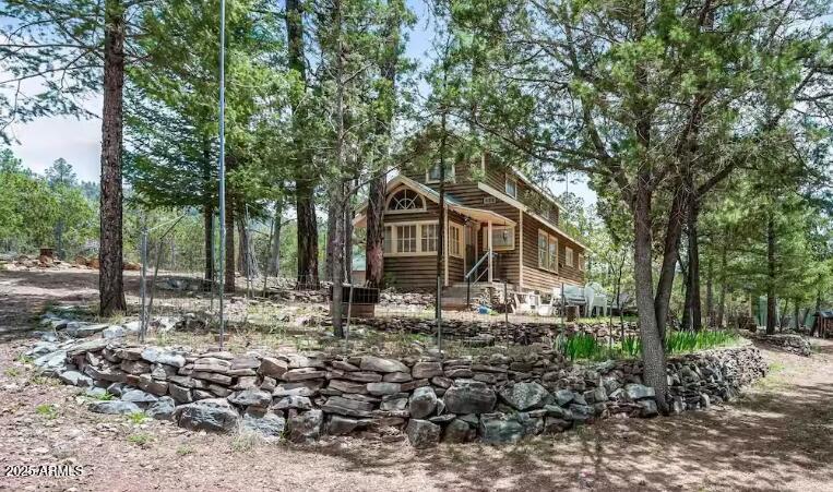 Situated on a large lot with room to build more; and Tucked into a quiet stand of pines near Payson, this inviting cabin is everything you want from a mountain getaway: warm, bright and effortlessly comfortable. The living area offers a classic wood-fired stove that fills the room with glow and crackle on cool evenings. Large windows wrap the main living spaces, bringing the forest inside with the views changing with every season.

The full kitchen is thoughtfully equipped for family meals and holiday feasts, with ample counter space and storage so cooking is a pleasure. A full bathroom is convenient and clean, and a washer and dryer make longer stays easy. The cabin's layout is spacious enough for board games, movie nights & family/friend gatherings. Firepit and storage/workshop