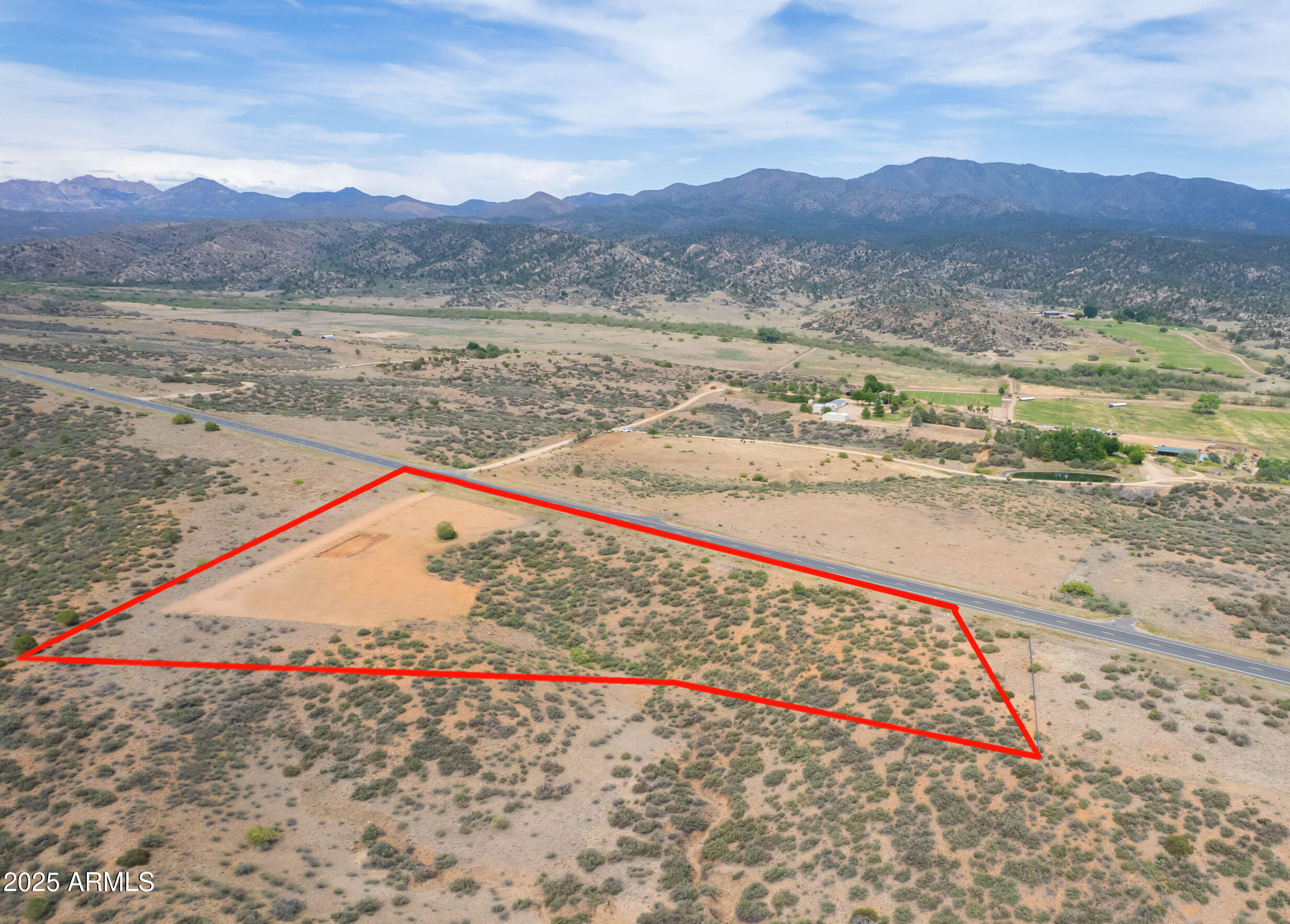 Bordered by State Land to the north and providing panoramic views of unique mountain ranges for miles in all directions, this 2.39 acre property has a well already drilled, conventional septic installed, soils test completed for building and is a dream come true. Recently cleared to streamline your building process, and a beautiful garden bed dug. Perfectly placed at the north end of highly desired Skull Valley and only 20 minutes from city amenities, you have the ideal blend of country living and modern convenience at your fingertips. Enter this property via your private driveway off of paved Iron Springs road through a private gate shared with just one other parcel. High Chaparral vegetation, unobstructed views of Black Mountain and Ferguson Valley, and gently rolling topography are only a few of the features that will cause you to fall in love with this location. NO HOA, no deed restriction. This is an opportunity you don't want to pass up. Electricity is in the area but this property is ideally situated for Off-Grid/Solar operation. The well is 325 ft deep and 38GPM at time of drilling!! That is great production and good, clean water!