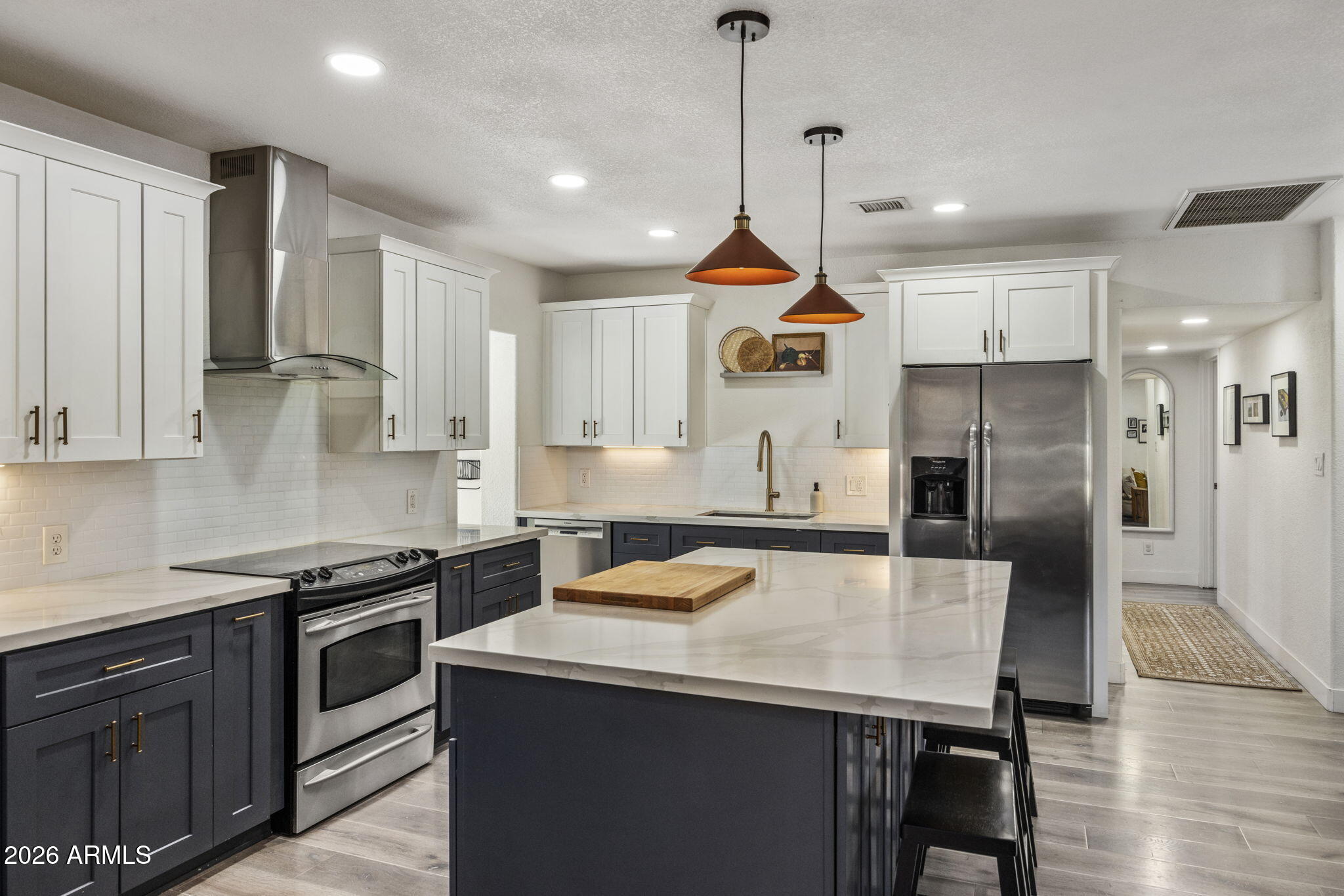 Beautifully remodeled red brick ranch in the heart of Arcadia Lite! Originally remodeled in 2019, this 4 bed, 2 bath home blends timeless character with modern design and thoughtful owner upgrades.

The open-concept main living space features wide-plank flooring and a designer kitchen with quartz island, shaker cabinetry, classic subway tile backsplash, and stainless steel appliances--perfect for everyday living and entertaining.

Recent owner improvements include an enclosed laundry room adding valuable square footage, and a fully reimagined primary suite featuring a walk-in closet, spa-like bathroom, and a charming hallway reading nook filled with natural light.

Situated on a corner lot, the home offers custom desert landscaping, a large grassy backyard with paver patio (More...) storage shed, inviting front porch, and a shaded 1-car carport.

Unbeatable location just minutes from The Vig, La Grande Orange, Postino, Lola Coffee, and other Arcadia Lite favorites. A true turnkey opportunity in one of Phoenix's most sought-after neighborhoods.