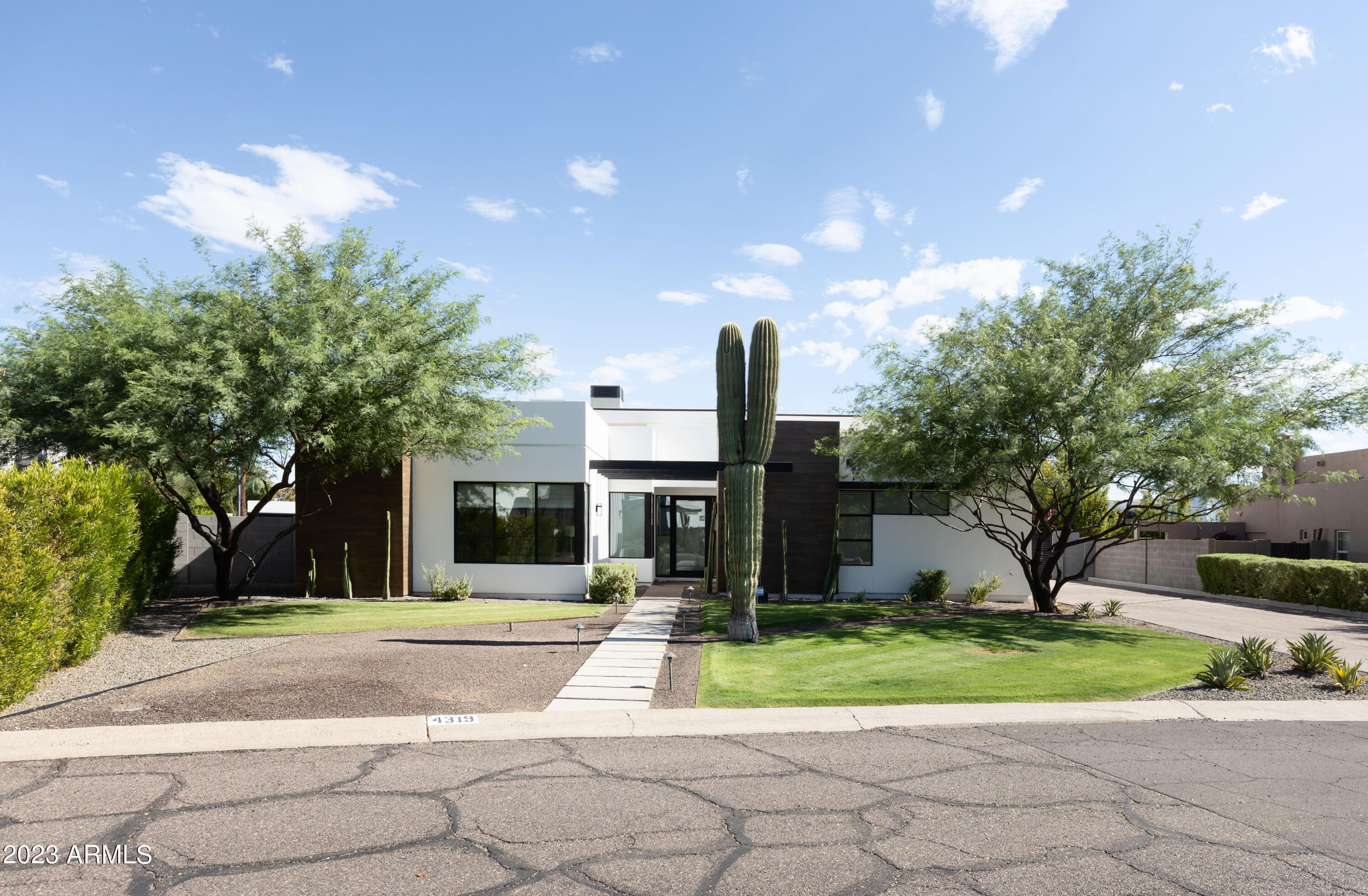 Nestled in the highly sought-after Arcadia neighborhood of Phoenix, this exquisite home offers a blend of modern luxury, timeless charm and a gorgeous view of Camelback Mountain. With its impeccable design and prime location, this property presents a rare opportunity to experience the best of AZ living. Situated in the prestigious 85018 zip code, this 5bed/4.5bath property is conveniently positioned near the bustling Biltmore and Old Town Scottsdale districts. Step inside to discover an open layout that seamlessly connects the living, dining, and kitchen areas. Large windows flood the interior with natural light, highlighting the carefully chosen finishes and details that create an atmosphere of refined comfort. The chef-inspired kitchen is a true masterpiece, featuring high-end stainless steel appliances, a spacious island with quartz countertops, custom cabinetry, and a stylish backsplash. The spacious master suite offers a peaceful retreat with a spa-like ensuite bathroom, complete with a soaking tub, dual vanities, and a walk-in shower. A generously sized walk-in closet provides ample storage space for your wardrobe. With 4 additional bedrooms and a den, this home accommodates a variety of living arrangements. Create a home office, fitness area, or playroom to suit your lifestyle. Step outside into your own private oasis. The backyard features a covered patio, perfect for al fresco dining, as well as a sparkling pool and beautifully landscaped gardens. This outdoor haven provides the ideal setting for relaxation and entertaining.

Boasting a blend of modern and traditional design elements, this home showcases a thoughtfully curated aesthetic. The exterior features stucco accents, a distinctive roofline, and lush landscaping that creates an inviting curb appeal. The home is equipped with modern conveniences, including energy-efficient features and a three-car garage. Don't miss your chance to own this exceptional residence in one of Phoenix's most coveted neighborhoods. 

Recent upgrades since completion of property: New Interior Paint - 2023, New Carpet - 2023, New Stucco - June 2023, Pergola - installed 2019, Shade Sails - installed 2019, AC in garage w/epoxy flooring 2019, Restoration Hardware Chandelier- 2023 Primary Bed + Bath, Video Cameras and Alarms system through Protection Source, Gas Heat for Pool installed Feb 2023, Gas line for Jacuzzi outside Primary Bedroom, Custom Shades and Curtains installed 2019, Dog run w/gate outside of Primary Bedroom, Every bedroom has TV mount as well as game room, living room, outside patio