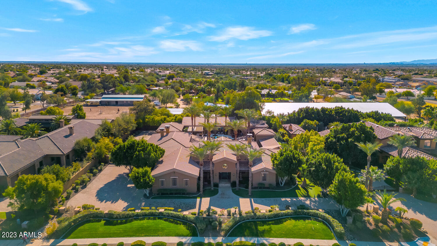 This sprawling estate is absolutely beautiful, sits in a dream worthy setting, and has something for everyone. It's a playground for kids, parents and grandparents alike. The kitchen is perfect for one who loves to cook and entertain, the living spaces are as dramatic as they are comfortable, the game room/man cave has an unreal restaurant style sports bar, the full home theater is incredible, the exercise room has its own sauna, the wine room is gorgeous, and all the bedrooms and baths are fantastic, including a master retreat with his and hers wardrobes, coffee bar and beautiful bathroom. The quality craftsmanship includes multiple fireplaces with carved canterra surrounds, custom iron, stone, tile and lighting, art niches, and furniture grade built-in cabinetry. The grounds are what takes the home over the top. An impressive pool, spa, water features, full outdoor kitchen, meandering covered and uncovered patios, stunning greenery and flower beds, and mountain views provide the most extraordinary Arizona ambience. This exceptional residence is all about family, entertaining and fun. An added bonus is there is an adjacent property available as well, for those who may be looking to create a high-end family compound or corporate retreat. This is a very special opportunity in an excellent location!