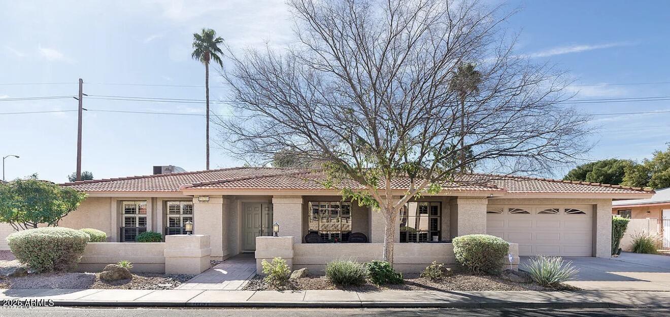 Welcome to this beautifully maintained home in the highly sought-after Dobson Ranch community, where resort-style amenities and an unbeatable location come together. Enjoy access to multiple community pools, scenic lakes, tennis courts, parks, a clubhouse, golf course, and miles of walking and biking paths, all with convenient access to the US-60 and Loop 101.

This spacious ranch-style home offers an exceptional floor plan with multiple living areas, including a formal living room, formal dining room, and an inviting family room. A stunning dual-sided fireplace creates the perfect centerpiece between the living spaces, while soaring vaulted ceilings with custom wood beam accents, recessed lighting, ceiling fans, neutral finishes, and newer carpet add warmth and character throughout. The beautiful kitchen is designed for both everyday living and entertaining, featuring granite slab countertops, a large center island, stainless steel appliances, a sunny breakfast nook, and a convenient butler's area with additional storage and workspace.

Retreat to the spacious secondary bedrooms, each offering generous room sizes and abundant closet space. Outside, you'll find your own private backyard oasis with mature shade trees, lush green grass, newer cool decking, and a sparkling Pebble Tec pool--the perfect setting for relaxing or entertaining family and friends.

With incredible living space, timeless charm, and one of Mesa's most desirable communities, this home truly has it all. Don't miss your opportunity to make this Dobson Ranch gem your own--this one won't last long!