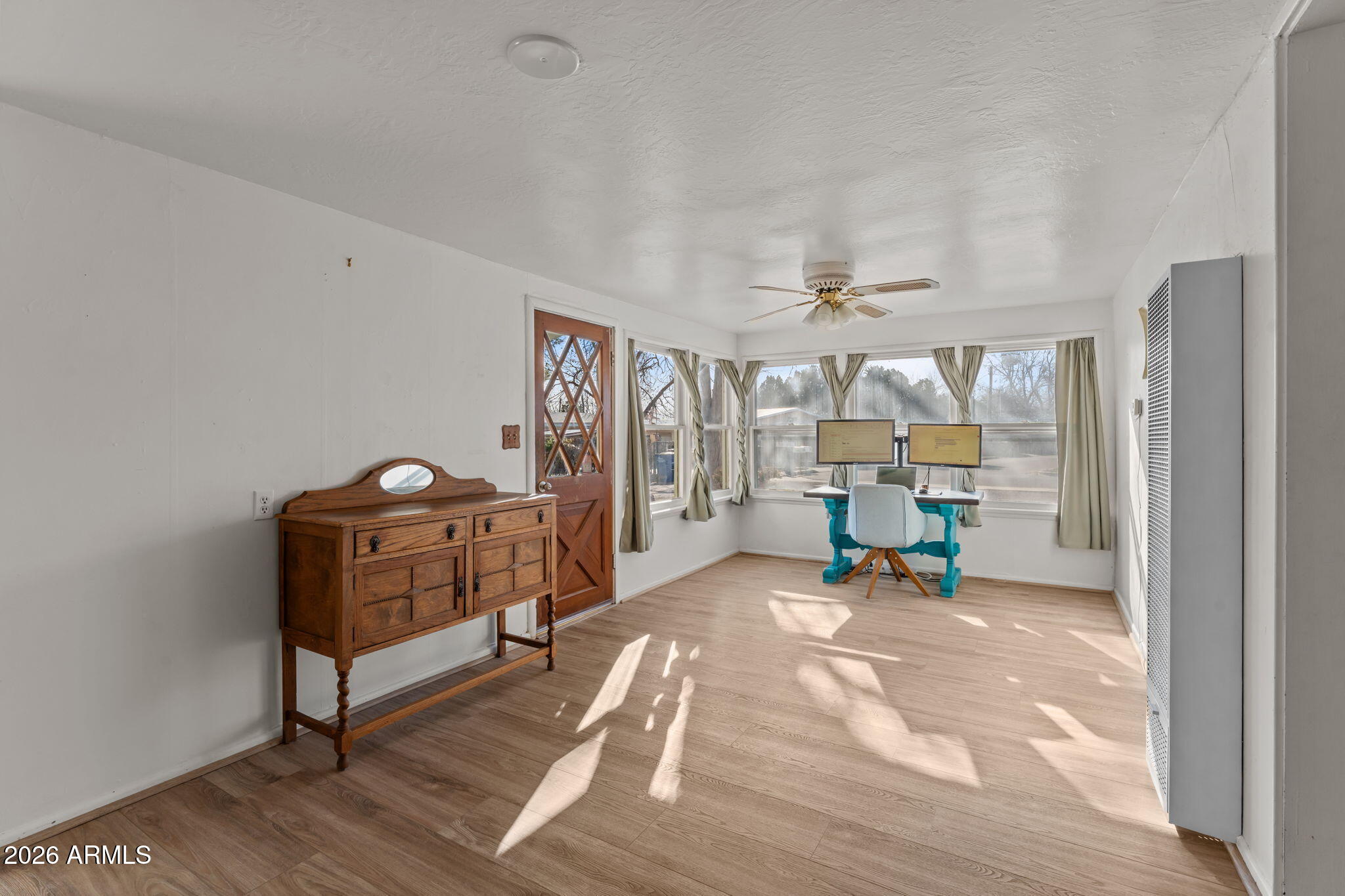 Charming 1923 home with timeless character and thoughtful modern updates, ideally located next to Coffinger Park and just steps from Old Town Wickenburg. This 3-bedroom, 2-bath residence offers updated vinyl flooring and a desirable split floor plan—ideal for guests or multi-generational living. One bedroom includes an ensuite bath and private entrance. Recent improvements include updated plumbing, Electric, On Demand hot Water, new sewer line. Set on over 18,000 sq. ft., enjoy mature landscaping plus a garage, workshop, and tack house. Walk to shops, dining, roping events, and more—this Wickenburg gem won't last!