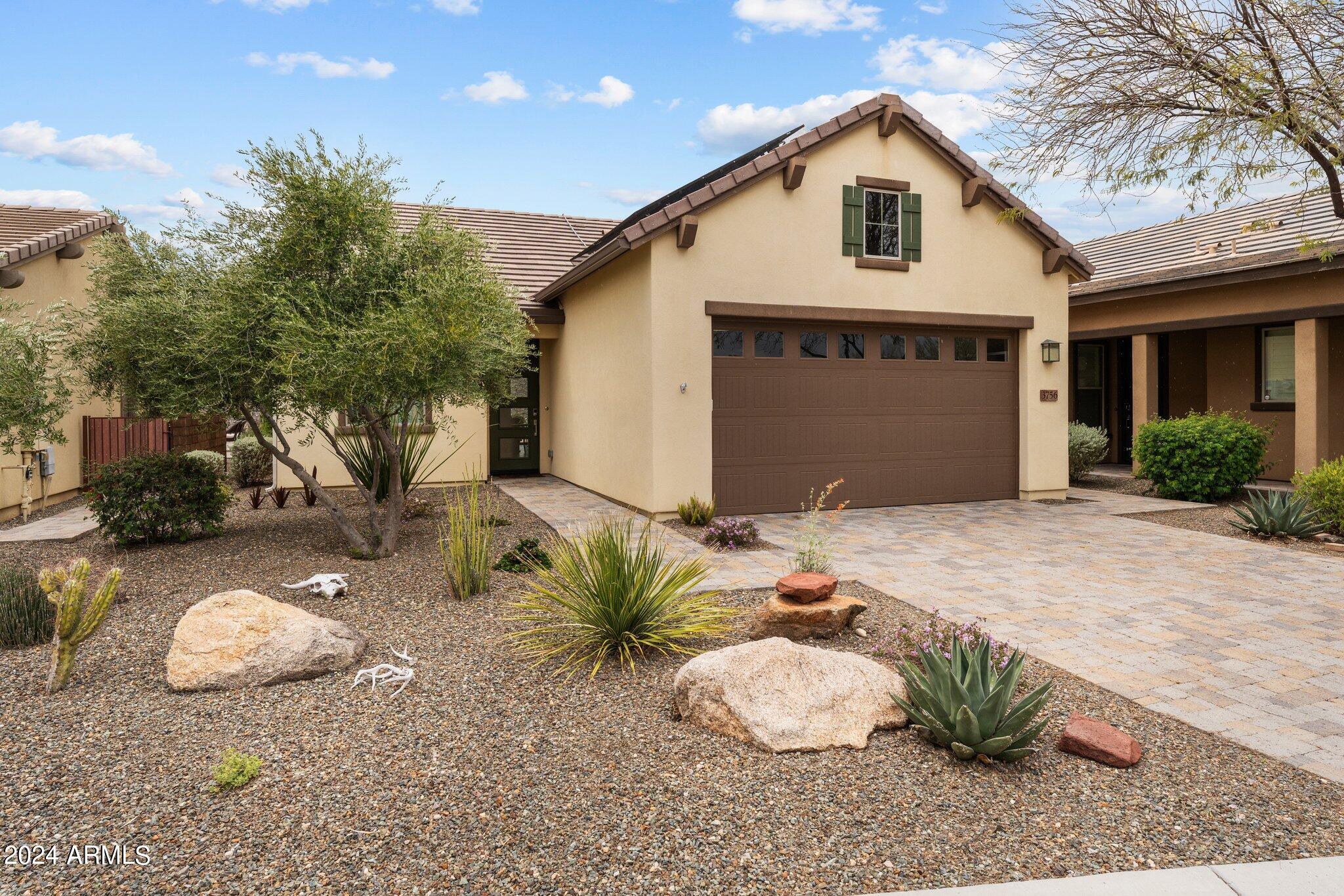Introducing the Palomino model—A versatile abode ideal for both year-round Arizona living and as a serene second home retreat. Nestled within the esteemed Sola collection, this residence offers the convenience of front and backyard landscape maintenance included in your HOA quarterly dues. Step inside to discover the timeless elegance of wood plank ceramic tile gracing the great room, kitchen, halls, and bathrooms. The kitchen boasts granite slab counters, stainless appliances, and pendant lights illuminating the island, perfect for culinary endeavors and gatherings alike. Experience seamless indoor-outdoor living with a sliding wall of glass leading to an extended back patio, enveloped by meticulously landscaped surroundings and remote-controlled sunscreens, creating a cozy outdoor sanctuary. The back patio has mechanical screens for privacy. Located near Charlie's Dog Park. The home has a dog run along the side of the house. Close to the Clubhouse, restaurant, tennis, spa, pool, and more. SOLAR!