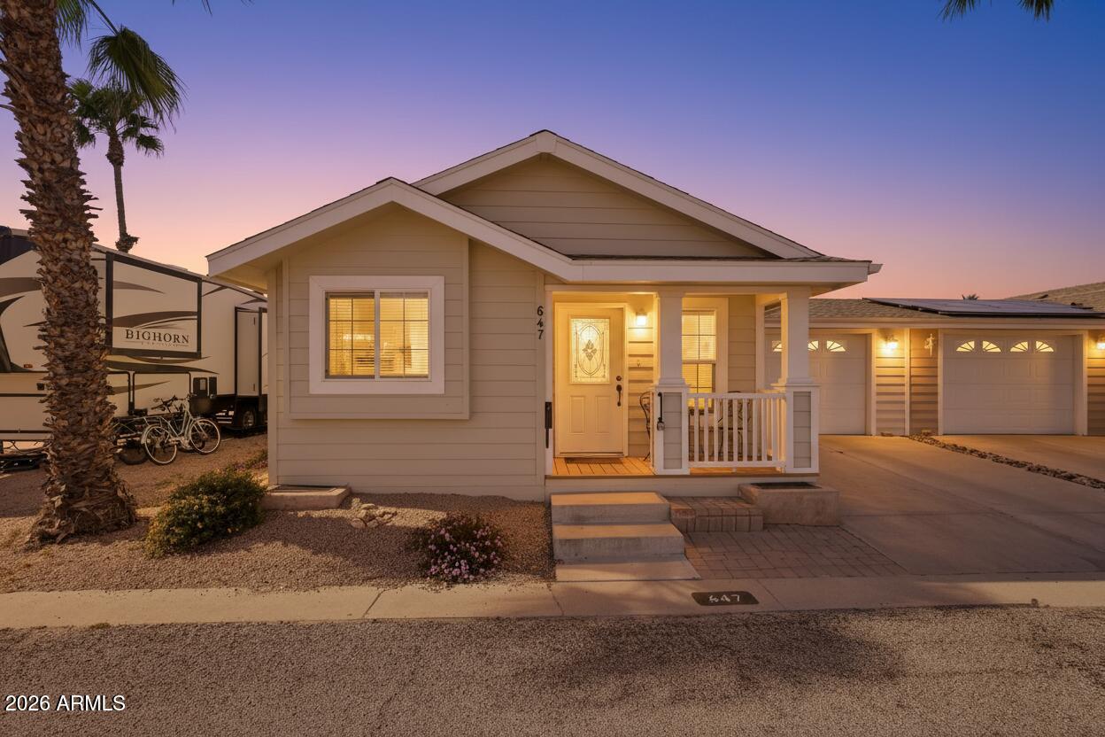 Located behind the guarded entrance of Pueblo El Mirage RV Resort, this turn key home offers a straightforward, low maintenance lifestyle within a well established 55+ community known for its depth of amenities and active atmosphere. Positioned close to the back/side gate, the location allows for an easy, quick exit when coming and going. Emergency services, including fire and ER facilities, are also conveniently nearby.
Inside, the home has been thoughtfully updated and is ready for immediate enjoyment. New flooring gives the interior a clean, refreshed look. The kitchen features updated stainless steel appliances that bring both style and practicality. A new A/C unit provides reliable comfort throughout the year. An oversized one car garage offers generous space, easily accommodating a vehicle plus a golf cart or additional storage. Everything you need is already in place, making this an easy move for a full time resident or seasonal owner. Pueblo El Mirage is designed for true resort style living. Residents have exclusive access to a top notch golf course, heated pool, fitness center, shuffleboard, tennis and pickleball courts, pet parks, laundry facilities, and even an on site post office. The community calendar is filled with optional activities, clubs, and events, creating opportunities to stay active and involved at your own pace. For those seeking a secure, amenity rich environment with convenience, connection to the neighborhood, and comfort, this home offers a practical and enjoyable way to experience it.
