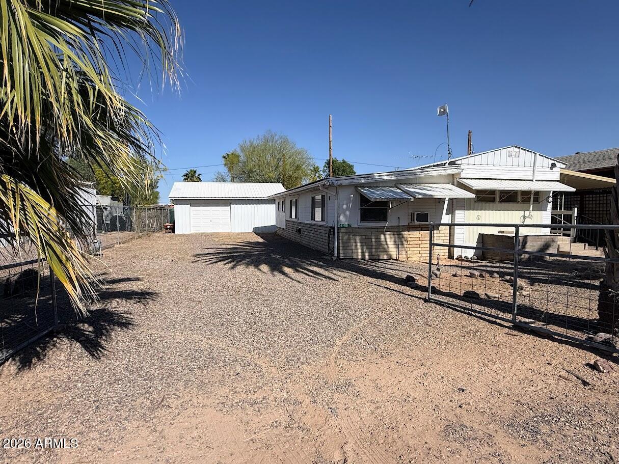 SELLER MOTIVATED!! SELLER WILLING TO CARRY!! This one is a little different in all the right ways. Offering 3 bedrooms and 2 bathrooms, this property started as a 1972 single-wide manufactured home (originally 2 bed, 1 bath) and has been expanded to include additional living space that truly makes it feel like more than you'd expect. The added-on section gives you a second living area, an additional bedroom, a full bathroom with a walk-in shower, and convenient inside laundry creating flexibility for guests, multi-generational living, or just spreading out. Outside, you'll find a large detached garage with electric, insulation, and a service entry door perfect for projects, storage, or keeping your toys out of the Arizona sun. Mature trees add shade and character, and there are multiple storage sheds for all your extras. If you're looking for something with space, functionality, and freedom to use it your way, this one is worth a look.