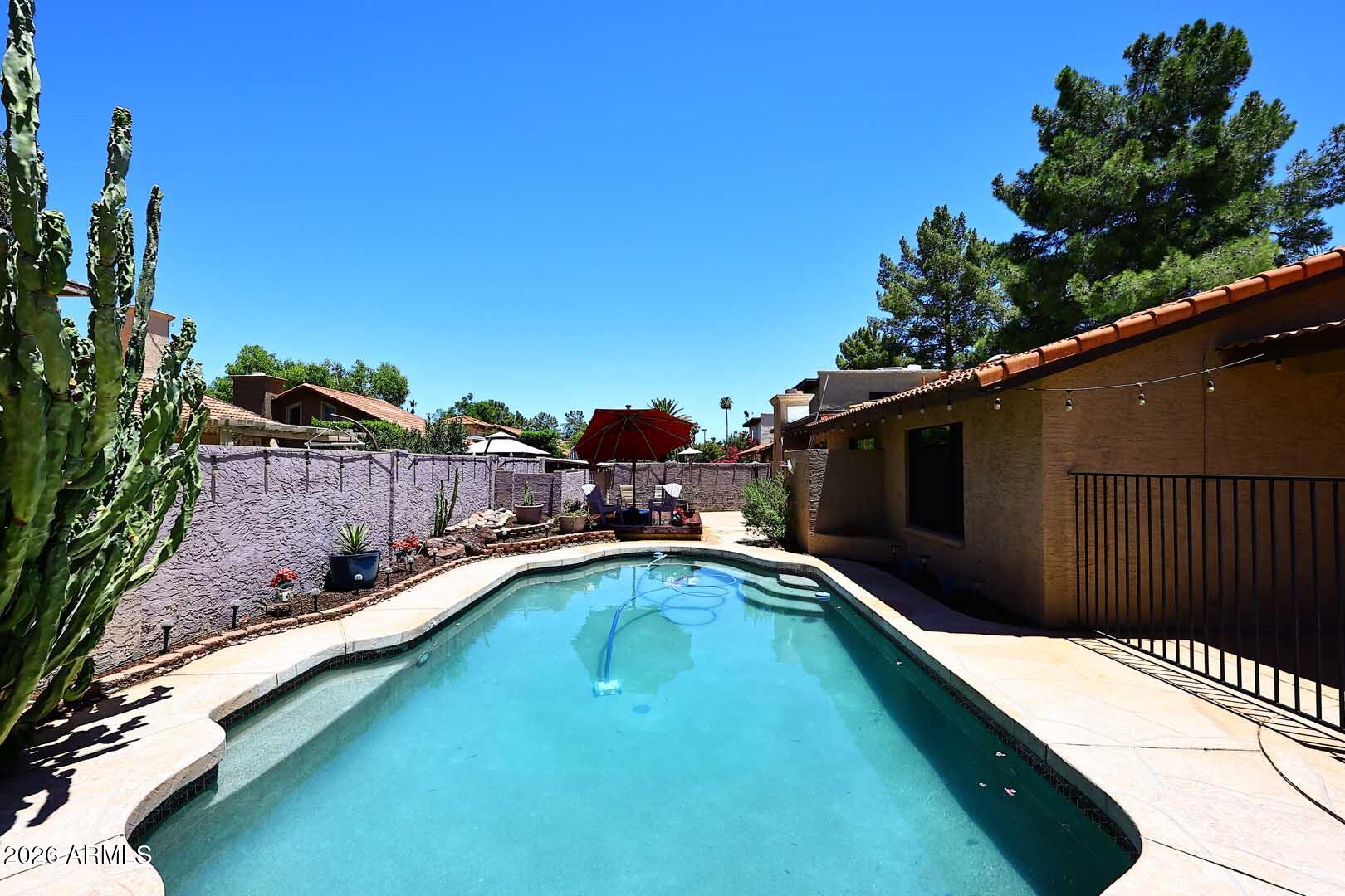 Welcome to this 3 bedroom, plus den, 2 bath home with a pool, just minutes from Downtown Gilbert in Breckenridge Manor, one of Gilbert's most desirable neighborhoods. Enjoy shaded tree lined streets & pathways, 2 playgrounds & plenty of grassy areas to play catch.  HOA maintains front lawns. New coating on flat roof, fresh paint inside & out, AC replaced 2023.  Separate den/office off entry, vaulted ceiling in living & dining, cozy retro conversation pit w/ fireplace. Updated kitchen lighting, cabinets w/ soft close drawers, granite counters, dbl oven, new dishwasher, kitchen island & large pantry. Tile & wood laminate flooring throughout, new carpet in one bedroom.  Large primary w/ separate shower/tub & access to bkyd. Sparkling pool & raised deck for relaxing.  This home is a must see!!