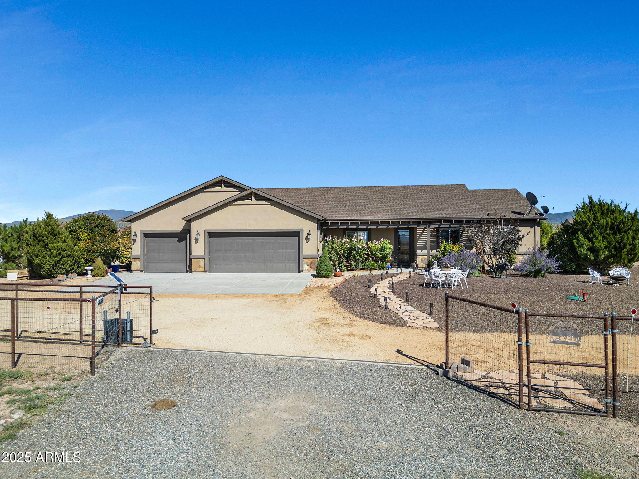Beautifully crafted custom single-level home on 2 fully fenced and gated acres in the desirable Lonesome Valley community. This 4BD/2BA residence offers an open floor plan with a chef's kitchen featuring granite counters, knotty alder cabinetry, walk-in pantry, and oversized island. The inviting living room boasts a corner fireplace, while the dining area opens to a spacious covered patio with mountain views. The primary suite is a retreat with dual vanities, tiled shower, garden tub, and walk-in closet. Outdoors enjoy professional landscaping, pergola, raised gardens, and cross-fenced acreage with a 2-run shedrow barn, feed room, solar fans, and RV parking with hookups. A 3-car garage, cistern tank, and numerous upgrades complete this exceptional property.