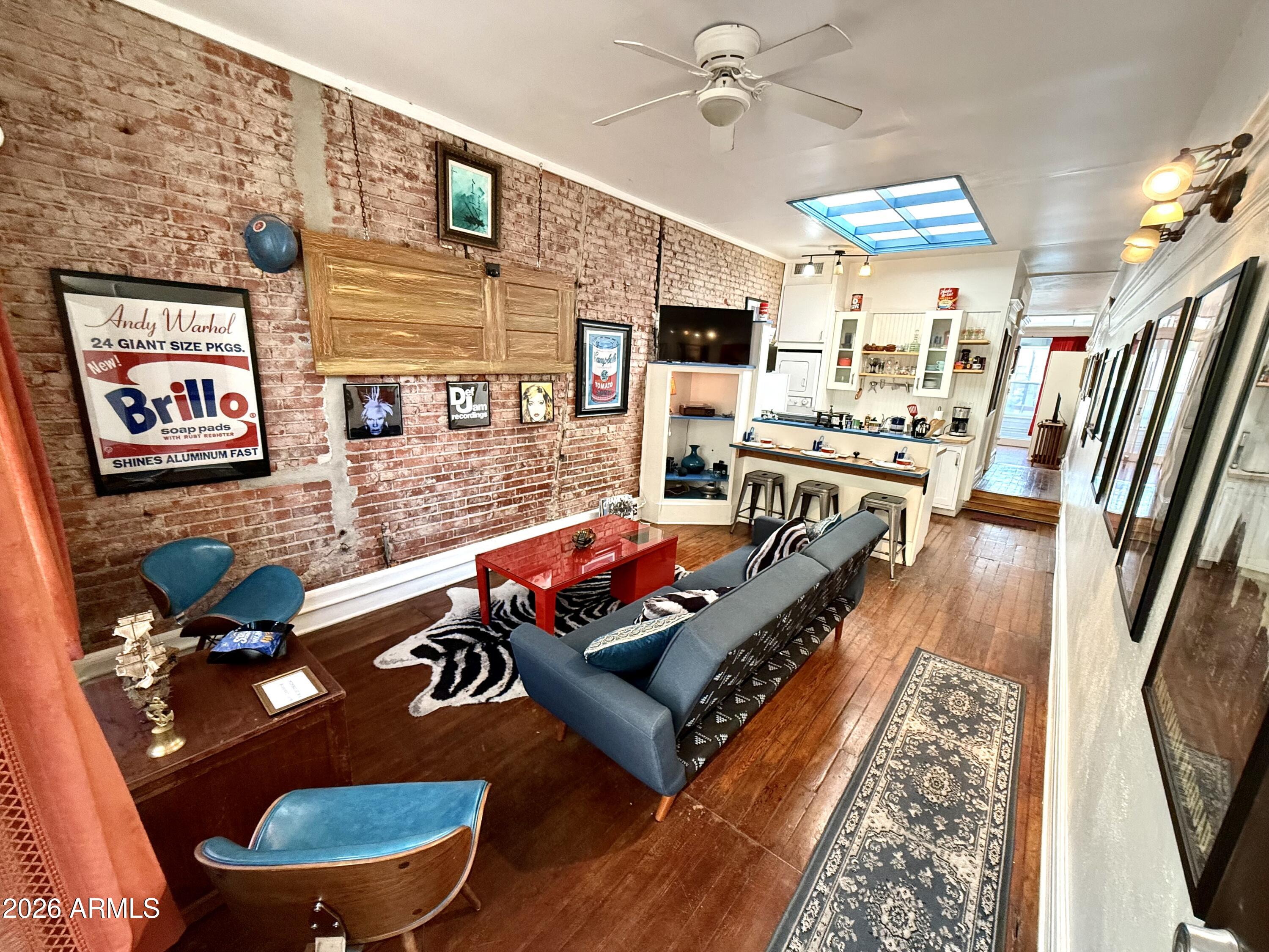 Upstairs is a beautifully appointed 809 sq ft 1-bedroom loft apartment with hip New York vibes, featuring original wood floors, exposed brick, & soaring ceilings & skylights. The views are unmatched. This gorgeous loft is a favorite on Airbnb, capitalizing on Bisbee's growing tourism market. 
At street level, is a restaurant space with seating room for 28+, complete with a commercial kitchen. An added bonus to this space is the huge storage cellar with time worn wooden timber stairs - wine cellar anyone? Keep 14 Main as it is or transform it with your imagination! HVAC on all levels for comfort. With its proximity to Main St's attractions & the town's reputation as a top travel destination (named one of Travel Lemming's 50 Best Places to Travel in 2024), Live, Work & Play all in one place This is an income producing property!  Street level commercial space has been leased to Skyhaven Wines.