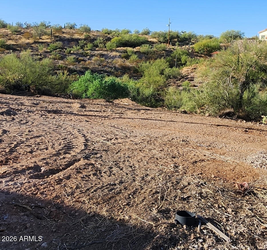 This parcel is over one acre in the manufactured home area of Queen Valley, an unincorporated area of Pinal County with no HOA. There is a cleared area off of Kathy Drive and another lower cleared area off of Burr Drive. There is power, sewer, and water to  pull/connect/bring to the property off of Kathy. The views from this parcel are beautiful, access State Land just up the street and enjoying hiking in the desert. Buyer to verify all facts and figures important to them.