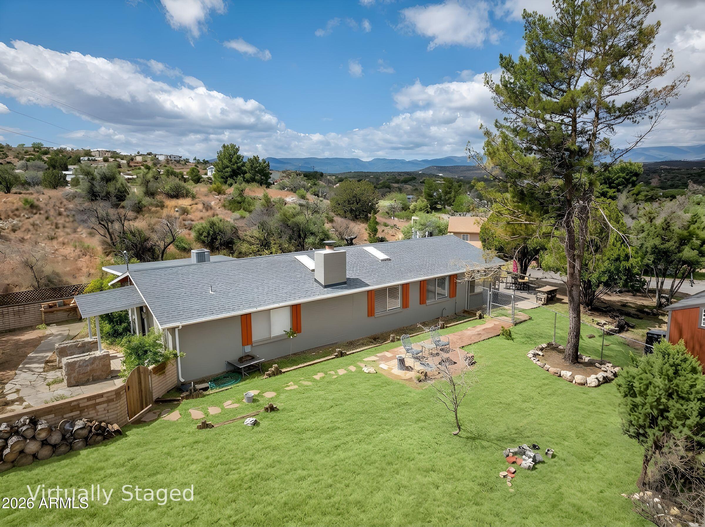 Priced to move and packed with value, this reimagined Arizona farmhouse on nearly an acre offers flexibility, upgrades, and income potential rarely found at this price point. Thoughtfully repositioned as a true 3 bed, 3 bath home with additional bonus/flex space(s) ideal for office, gym, media/game room, or creative studio. One private bedroom suite features its own entrance and bathroom, perfect for guests, multigenerational living, or rental income. Remodeled living room features a brick fireplace with new tile surround and mantel, skylights, fresh paint, sealed ductwork, and new blinds throughout. Kitchen includes brand-new Samsung refrigerator and dishwasher. New $10K fencing plus detached 12x40 double-loft barn cabin with independent electrical creates endless possibilities for extra storage, workshop, guest quarters, studio, tiny home conversion, or additional income space.  Enjoy breathtaking Arizona sunsets and sunrises from your own private scenic lookout point. 

This home features several bonus spaces that can be used for additional bedrooms, offices, a theater, game room, exercise or yoga room, or creative studio space. The possibilities are truly endless. Previously appraised at $497,000 in March 2025, before additional improvements and property enhancements completed by the sellers.