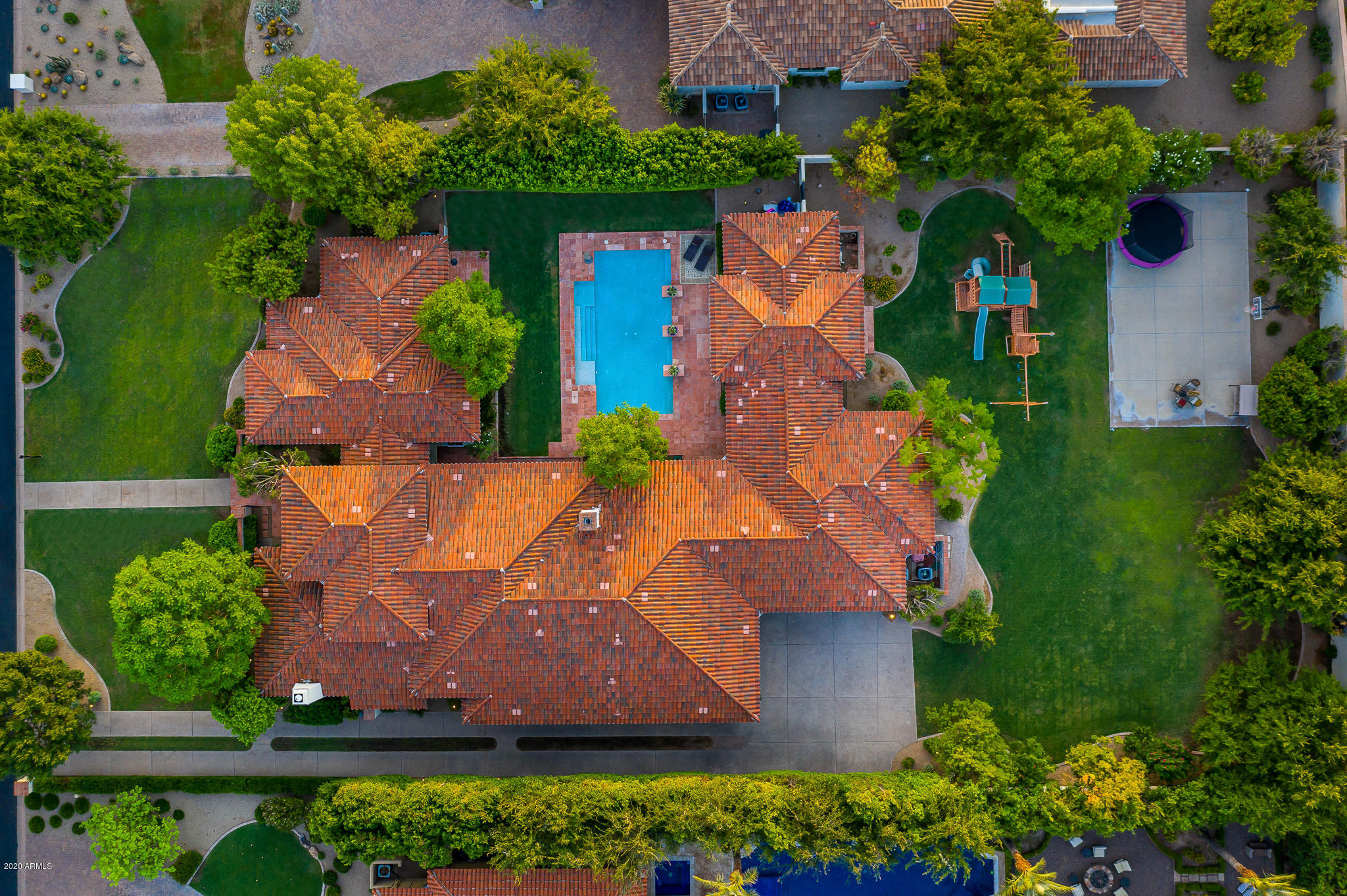 The marquis home of Gainsborough, this elegant Edmunds-built residence graces a near-acre in Arcadia. Custom built as the homebuilder's personal residence. Lush greenery screens the inner courtyard & expansive backyard. Camelback views inspire from the generous outdoor living area. Ample natural light plays upon classic Santa Barbara Saltillo tile - a nod to old world charm & warmth. This home exudes the character a discriminating buyer desires. Curated designer touches abound: carved beams & doors, custom ironwork & corner accents above the baseboards. The quality and impeccable flow of this single-level, split floor plan beckons you to explore each room. Close proximity to the Waterfront, Fashion Square's luxury corridor & all that Scottsdale offers. Schedule your private tour today.