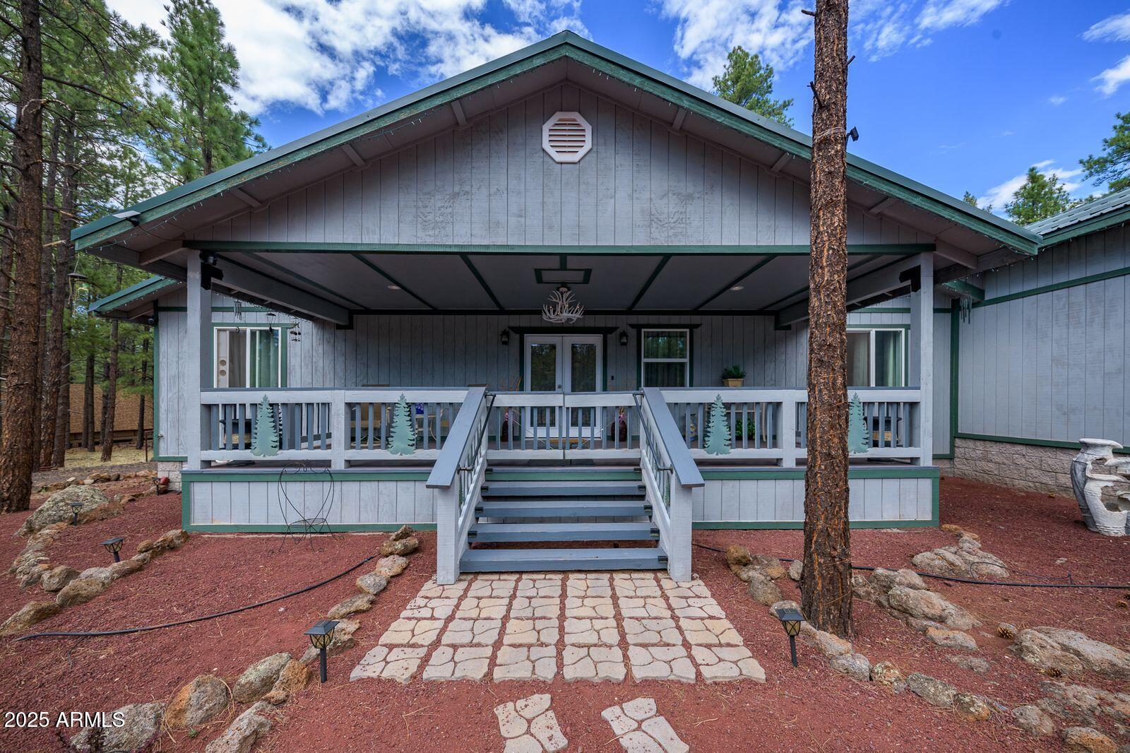 Welcome to your private retreat nestled in the pines. This custom-built home is a luxurious getaway which offers the perfect blend of modern comfort and nature's beauty.

Inside, you'll find two spacious primary suites, each with its own ensuite bathroom and direct access to the outdoor living areas. A versatile bonus room currently serves as a home office but could easily become a third bedroom to suit your needs.

Step outside onto a 20'x50' fully covered, screened in, climate controlled outdoor living space that feels like a resort in the woods. Enjoy forest views while you cook in the outdoor kitchen and living space.

The expansive 4-car garage/workshop is a true highlight. Equipped with 400-amp service & an RV electrical hookup. The setting & ambiance are simply unmatched.