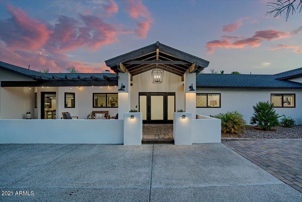 Arrive & prepare to fall in love with this stunning home! Step into this bright, open floor plan to immediately gaze out the wall of windows overlooking the backyard. The 12' ceilings, refinished hardwood floors, two large living spaces, & 2-way fireplace will impress every guest. Recently remodeled in 2021, the chef's kitchen is a host's dream with new ss appliances, shaker cabinets, quartz tops on the massive island & hand-cut, opal glazed tile backsplash. Enjoy the newly built wet bar in the sitting room overlooking the backyard. An entertainers dream is taken to another level in this Camelback Inn-like property featuring an expansive patio w/ vaulted ceiling for dining, fireplace, BBQ area complete w/ a smoker & stunning landscape all leading to the newly finished pool & ramada. With over 5,000 SF of living space, 5 beds & 5 baths, on .82 of an acre, this estate offers a space for everyone! The primary suite is breathtaking with soaring 12' ceilings finished with tongue & groove millwork & raw timber beams. The designer touches continue in the spa-like bathroom with quartz counters, concrete stone floors & a stand-alone tub. Located just minutes from the exclusive Scottsdale Airpark, this property will place you in the middle of our Valley's best golf, dining & shopping while offering a private sanctuary to call home. Call today to schedule your private showing!