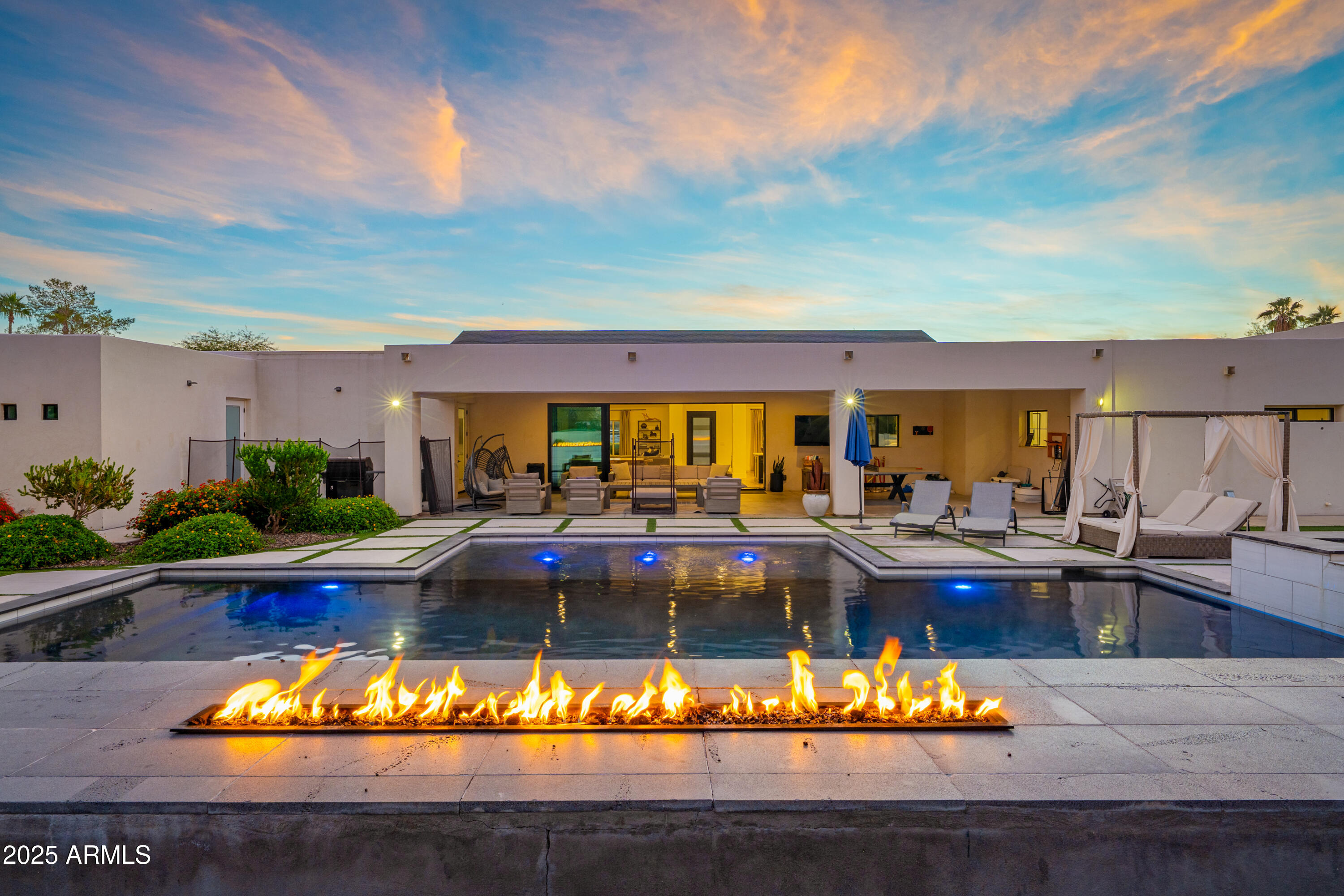 A rare desert sanctuary in the heart of the magic zipcode 85254, this fully rebuilt estate sits on a generous 0.59-acre lot with no HOA and delivers a refined blend of modern luxury and resort-style living. Thoughtfully designed with a split floorplan and a private casita, the home offers excellent functionality and solitude. A 20' custom sliding wall opens the great room directly to the backyard, seamlessly connecting the interior to a resort-style oasis. Each bedroom includes an en-suite bath and walk-in closet. Daily living is enhanced by an expansive laundry room with dual washer/dryers and a large walk-in pantry with an additional refrigerator.
The backyard is a true luxury desert playground, featuring a heated lap pool with waterfalls and fire features, a heated spa, outdoor TVs, covered dining patios, multiple fire pits, and generous lounge areas. Recreational amenities include a state-of-the-art pickleball/tennis court, NBA-style basketball court, regulation grade bocce ball court, shuffleboard, a seven-hole putting green, ping-pong, and a dartboard with digital score tracking. The fun is endless here! 
Located minutes from Kierland Commons, Scottsdale Quarter and the reimagined Paradise Valley Mall, this property offers exceptional comfort, convenience, and year-round resort living.
**Please note that this is an active short term rental- incredible income producing & guest favorite. Furniture available upon a separate bill of sale.**