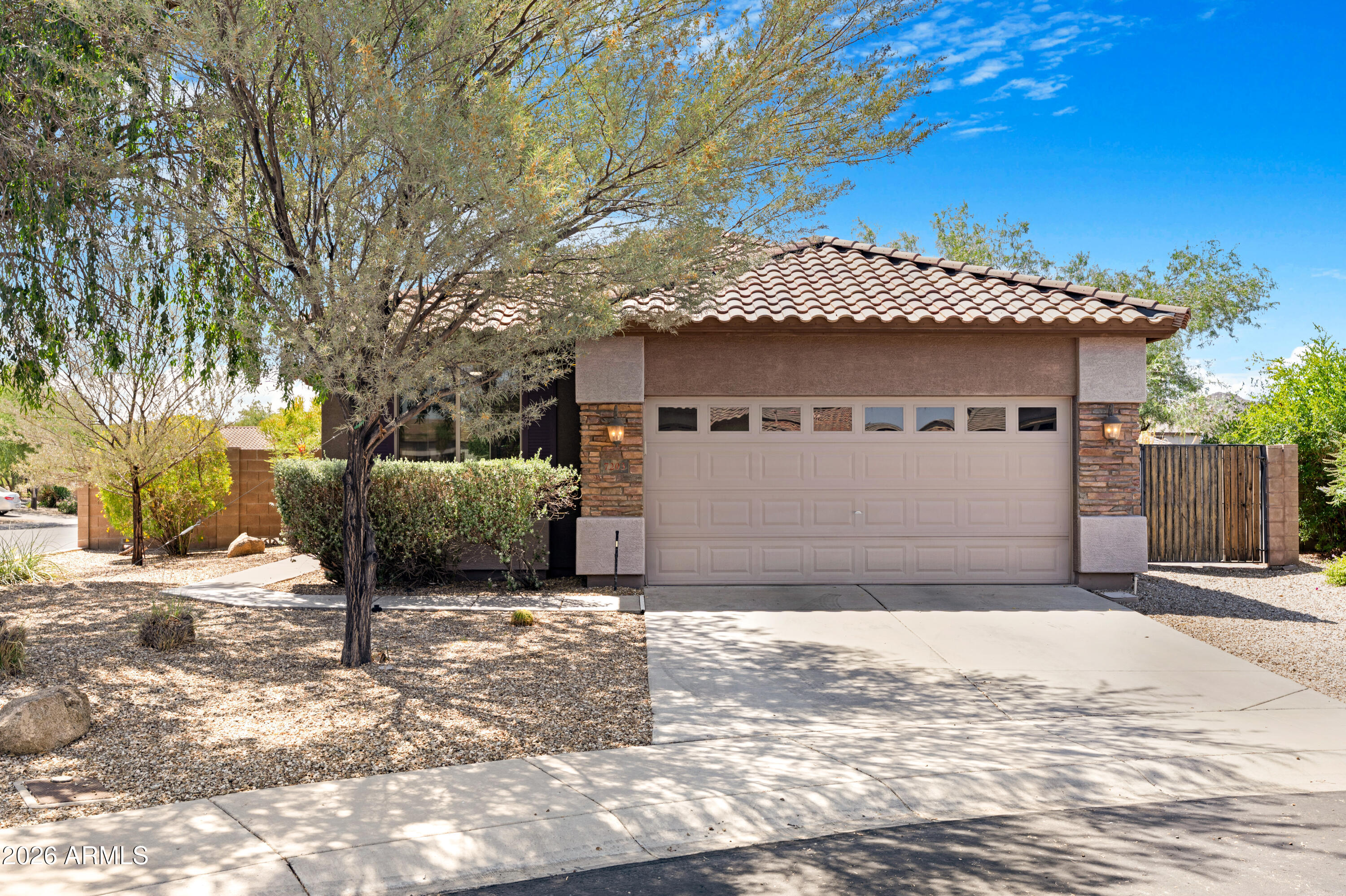 Located in the highly sought-after Sonoran Mountain Ranch community, this beautifully updated 4-bedroom, 2-bath home sits on an oversized cul-de-sac corner lot with exceptional curb appeal and an RV gate. Offering the perfect blend of comfort, functionality, and modern updates, this move-in ready home features fresh interior paint, newer carpet, updated light fixtures, and brand-new appliances throughout.
The open-concept floor plan showcases a spacious kitchen with abundant cabinetry, ample counter space, and a seamless flow into the dining and living areas ideal for both everyday living and entertaining. 
Step outside to an expansive backyard designed for Arizona living, complete with a covered patio, extended paver seating area, mature landscaping including citrus trees, and plenty of room for entertaining, play, or future customization. The oversized lot offers added privacy and rare usable outdoor space, while the RV gate provides convenience for toys, or additional storage needs.
Additional features include upgraded tile flooring in main traffic areas, dual-pane windows, spacious secondary bedrooms, and a private primary suite with walk-in closet and dual vanities. Ideally located with convenient access to the growing TSMC semiconductor corridor, Lake Pleasant Parkway, and the new Trailhead shopping center featuring dining, retail, and everyday conveniences. Residents also enjoy proximity to parks, hiking and biking trails, top-rated schools, and mountain preserves, making this home the perfect combination of lifestyle, location, and livability.