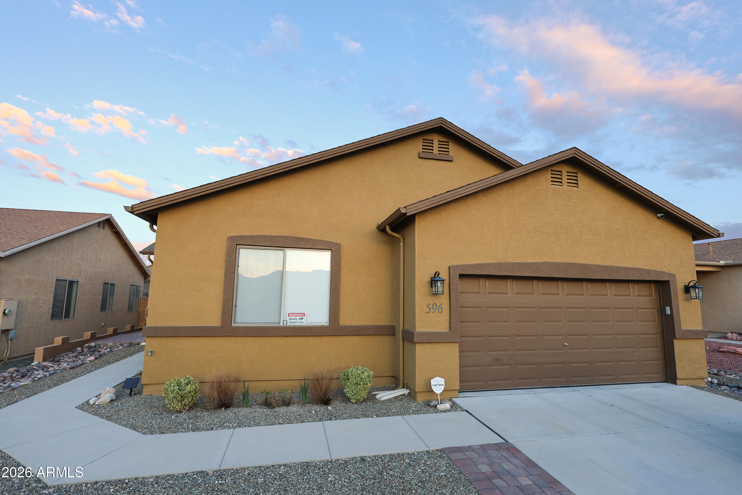 OVER $84,000 IN UPGRADES SINCE PURCHASED IN 2023. This beautiful move-in ready 4 bed, 2 bath home with major upgrades already completed and a luxurious backyard built for relaxing and entertaining. Seller improvements include a new HVAC, exterior paint, water filtration system, new screen doors, blinds, toilets, HVAC/duct cleaning, and a backyard transformation with pavers, irrigation, raised garden beds, added trees and shrubs, backyard electrical, outdoor kitchen, and fireplace. The spacious layout has high ceilings, comfortable living areas, and a generous master suite. Whether you're hosting friends under the covered outdoor kitchen or enjoying a night by the fireplace watching an Arizona sunset, this home offers the kind of indoor-outdoor lifestyle buyers hope to find but rarely do.
