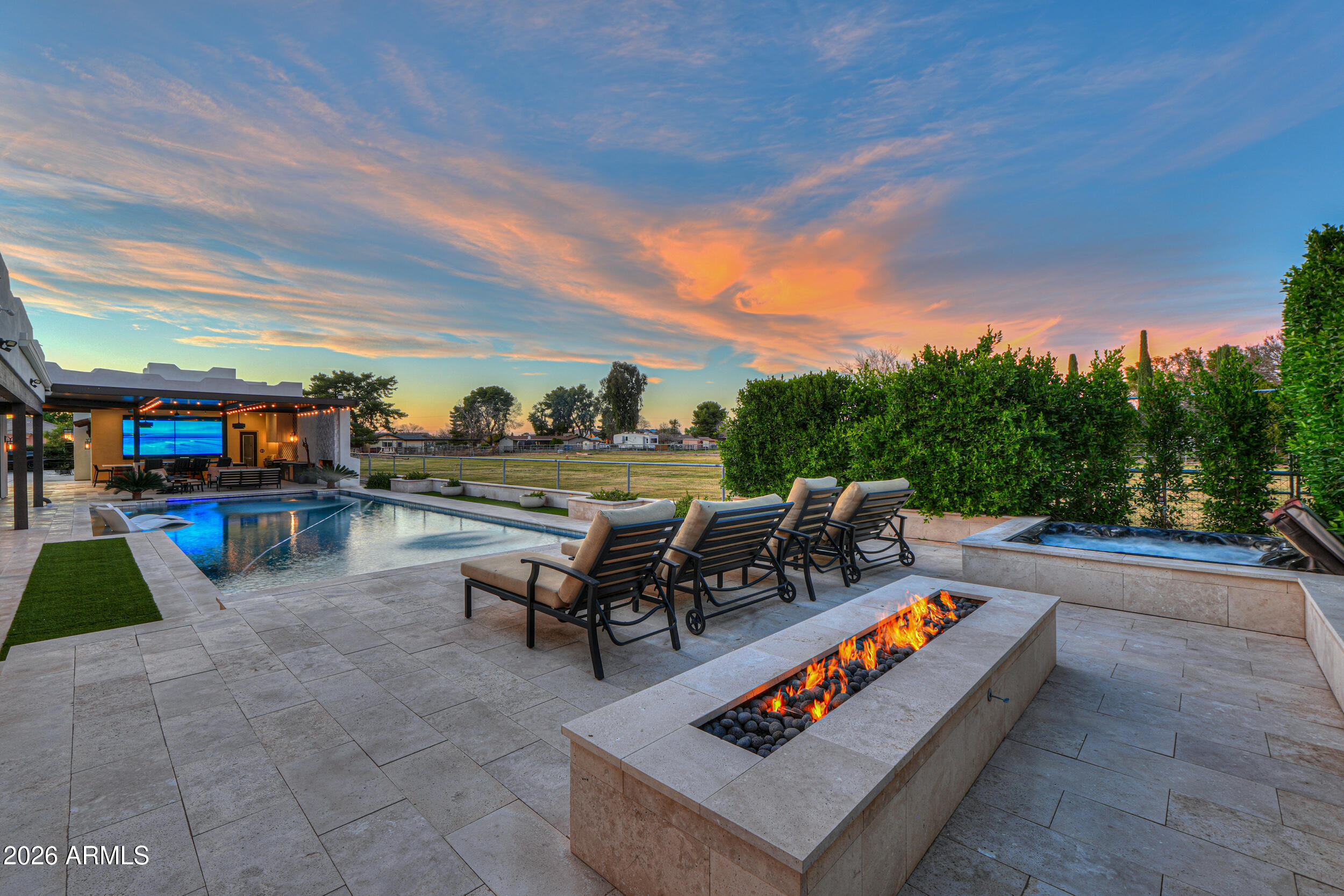 Discover your dream entertainer's paradise! This spectacular residence boasts 6 spacious bedrooms, 4.5 luxurious bathrooms, home theater, gym and separate office. The impressive 9-car garage features 3 vehicle lifts totaling 12 spots, providing exceptional storage for your automotive collection. Inside, a beautiful kitchen awaits with a huge island and soaring vaulted ceilings that create an open and airy atmosphere. Step into your backyard oasis and cool down in your stunning swimming pool, complimented with an out door kitchen and granite countertops for hosting unforgettable gatherings. The property also features a pickleball, volleyball and basketball court, ensuring endless fun and recreation. Additionally, a charming casita is attached to the RV garage, offering versatile living!