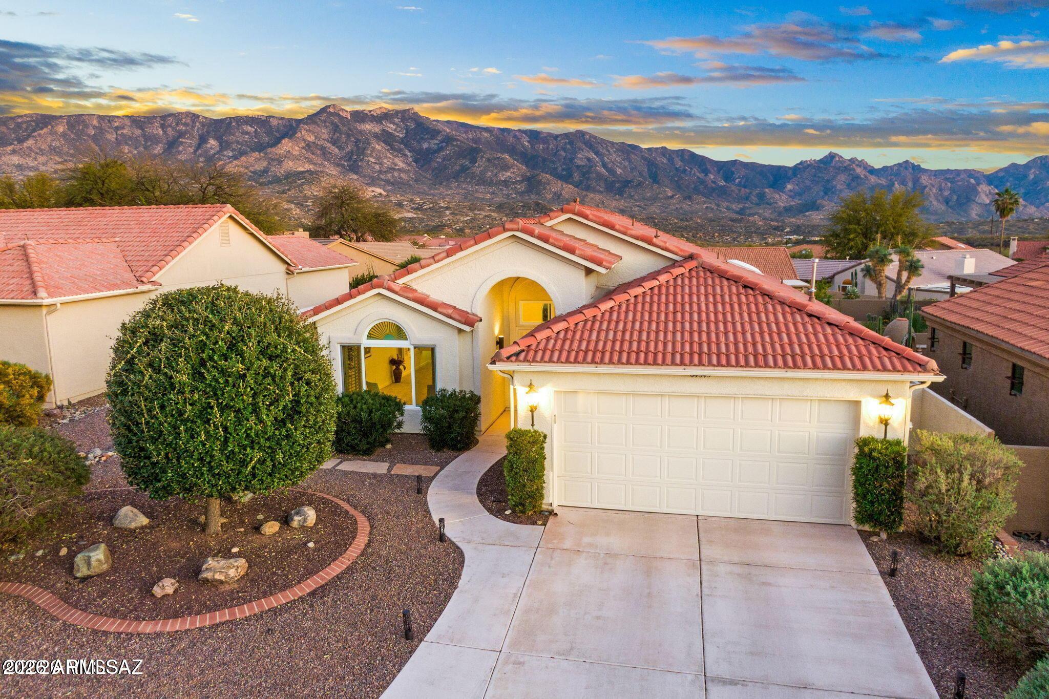 Over $122,000 invested in improvements completed within the past 12 months throughout this extensively remodeled SaddleBrooke home, where near unobstructed mountain views stretch far beyond what photos can capture. Set on one of the community's most desirable streets--known for its larger lots and thoughtfully enhanced homes--this property offers both exceptional setting and substance. Showcasing 1,883 sqft of single-level living, this 2-bedroom, 2-bath residence has been reimagined from the ground up--taken down to the drywall and concrete to create a truly modern, move-in ready home. Major upgrades have been completed, including a new roof with warranty, new Milgard windows and sliders, new exterior paint, all-new high-end luxury vinyl plank flooring and upgraded carpet with memory foam padding, as well as updated electrical and plumbing systems for long-term peace of mind.

At the heart of the home, a $50K+ kitchen and family room transformation expands the living space and introduces a more open, light-filled layout. The redesigned kitchen features new cabinetry, quartz countertops, stainless steel appliances, and a large island with snack bar--all opening to walls of picture windows and sliding glass doors that frame sweeping, elevated views of the Santa Catalina Mountains.

Both bathrooms have been upgraded with new 36" cabinetry, plumbing, sinks, and fixtures, while interior improvements--including wall and ceiling refinishing, fresh paint, removal of dated features, and new baseboards throughout--reflect a consistent level of care and attention to detail.

Importantly, this is not a quick cosmetic flip. Every improvement was completed by the current owner with the intention of personal use, resulting in a level of quality, investment, and finish that goes well beyond the typical remodel.