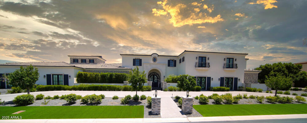 Impeccable 6-bedroom, 8-bath, 11,800 sq. ft. custom estate offers a stunning blend of luxury and modern elegance on a pristine 1-acre lot within the prestigious San Tan Lakeside Estates. Set against the backdrop of breathtaking mountain views, this waterfront property boasts a private 13-acre ski/wake/paddleboard lake and 236ft of lakefront beach. The home features expansive sliding glass wall panels that open on two levels to reveal panoramic lake views, seamlessly merging indoor and outdoor living spaces. Inside, a chef's dream awaits with a gourmet kitchen outfitted with high-end finishes, two oversized kitchen islands, wine room, and a butler's pantry. The upstairs entertainment bar and game room includes a second kitchen, , and abundant indoor and outdoor seating perfect for hosting guests. All six bedrooms offer en-suite bathrooms, ensuring privacy and comfort for everyone. The master suite's spa-like bathroom is a true retreat with luxurious finishes, expansive designer closets, steam shower, and a deep soaking tub.
This family-friendly property is designed for leisure and entertainment, with resort-style amenities throughout. There is an indoor basketball half court. The 1580 sq. ft. diving pool has a swim-up bar, built-in spa, and a slide cascading from the second floor.
There are two covered outdoor BBQ cooking areas, one near the pool and another overlooking the lake. Additional highlights include a workout room with sauna; pickleball court, putting green, two built-in trampolines, and an oversized RV garage with space for seven cars. A private boathouse with a hydro lift offers easy access to the water. The custom courtyard and pergola add a touch of elegance to the outdoor space. This estate offers the ultimate in luxury living with every detail meticulously crafted.