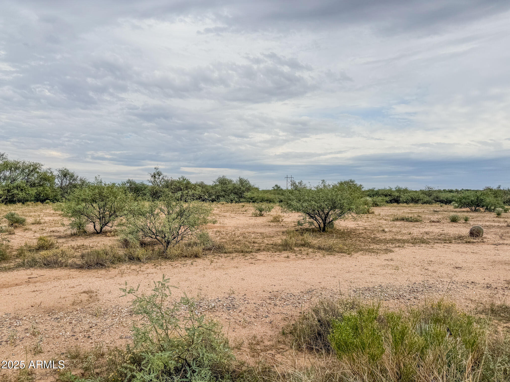 Discover 5+ acres of wide-open space just west of Benson, offering the perfect blend of rural tranquility and convenience. This level, usable parcel provides plenty of room for your dream home, horses, or hobby ranch—with beautiful 360-degree mountain views and stunning Arizona sunsets. Located just off Tequila Trail, the property offers easy access to I-10 for a quick drive to Benson or Tucson. Power is nearby, and there is abundant space for a private well and septic system. Experience peaceful country living with the freedom to create your ideal desert retreat!
The property is a 5.8-acre portion of 12406005B—survey to be recorded at closing.