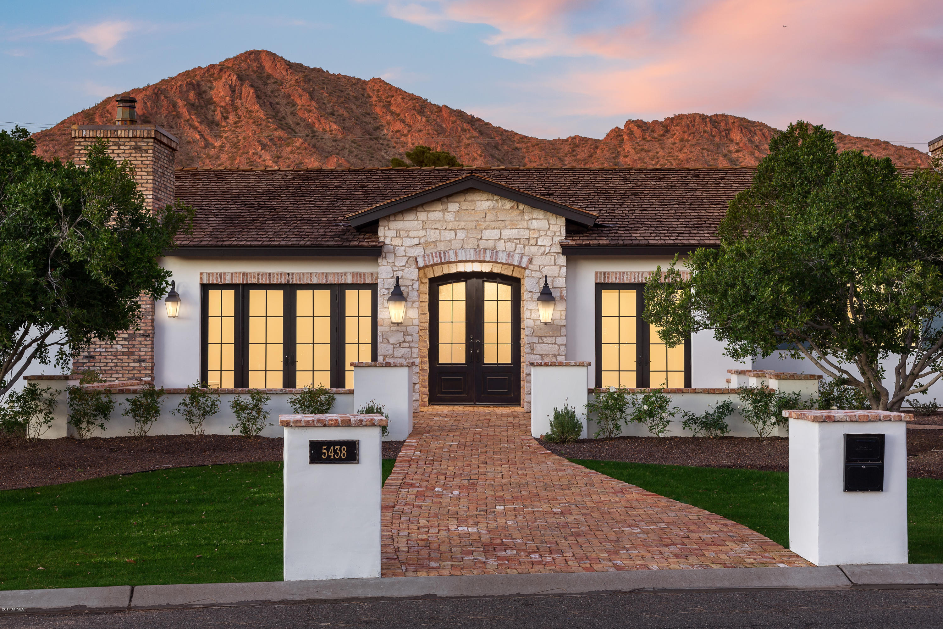 This is what Arcadia living is all about! Charm, character, great taste, colorful palette, sun filled rooms and fantastic spaces for the family to play and entertain. The perfect design includes a beautiful kitchen with a huge island, a private office, a magnificent great room with fully retractable doors showcasing the gorgeous covered patio, extra large bedrooms and stylish baths with great custom elements. Artistic tile, granite, marble, custom furniture grade cabinetry, extensive quality millwork, exposed brick and pristine wood flooring just begin to highlight the creative design, and that's just the inside. The outside is every bit as impressive with outstanding curb appeal, an impressive pool and spa, conversation fire pit and incredible mountain views. It's easy to imagine creating unforgettable memories in this phenomenal residence!