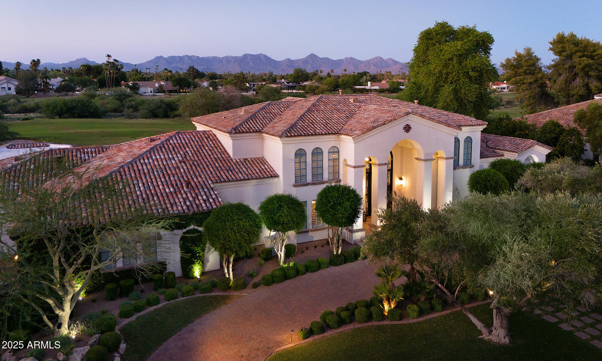 Stunning Santa Barbara on the par 5, 7th hole at Camelback CC w/ McDowell Mtn. views.... Never before on the market! Built by Kensington in 1995 and beautifully renovated in 2013 by American Traditions incl. rich finishes & fine detailing throughout.  Kitchen completely updated in 2024.  Elegant entry foyer showcases 20' picture window trimmed in canterra stone, overlooking the Ambiente course.  Polished granite/ wood plank flooring / alder beamed ceilings create character with quality and warmth.  Leaded glass accents complement the executive wood paneled study, as well as the finely crafted transom window in the gracious Primary Suite.  Upstairs is a mini-master suite w/ view deck + 2 en suite bedrooms.  Private home theater adjacent to Family Rm.  Separate 384 sf Guest House with pool bath.  Lushly mature landscaping adds tremendous privacy, defining the rear yard which surrounds the heated pool, spa, & canterra stone bancos w/ firepit, putting green, pretty raised planter, and plethora of patio spaces for entertaining family & friends.