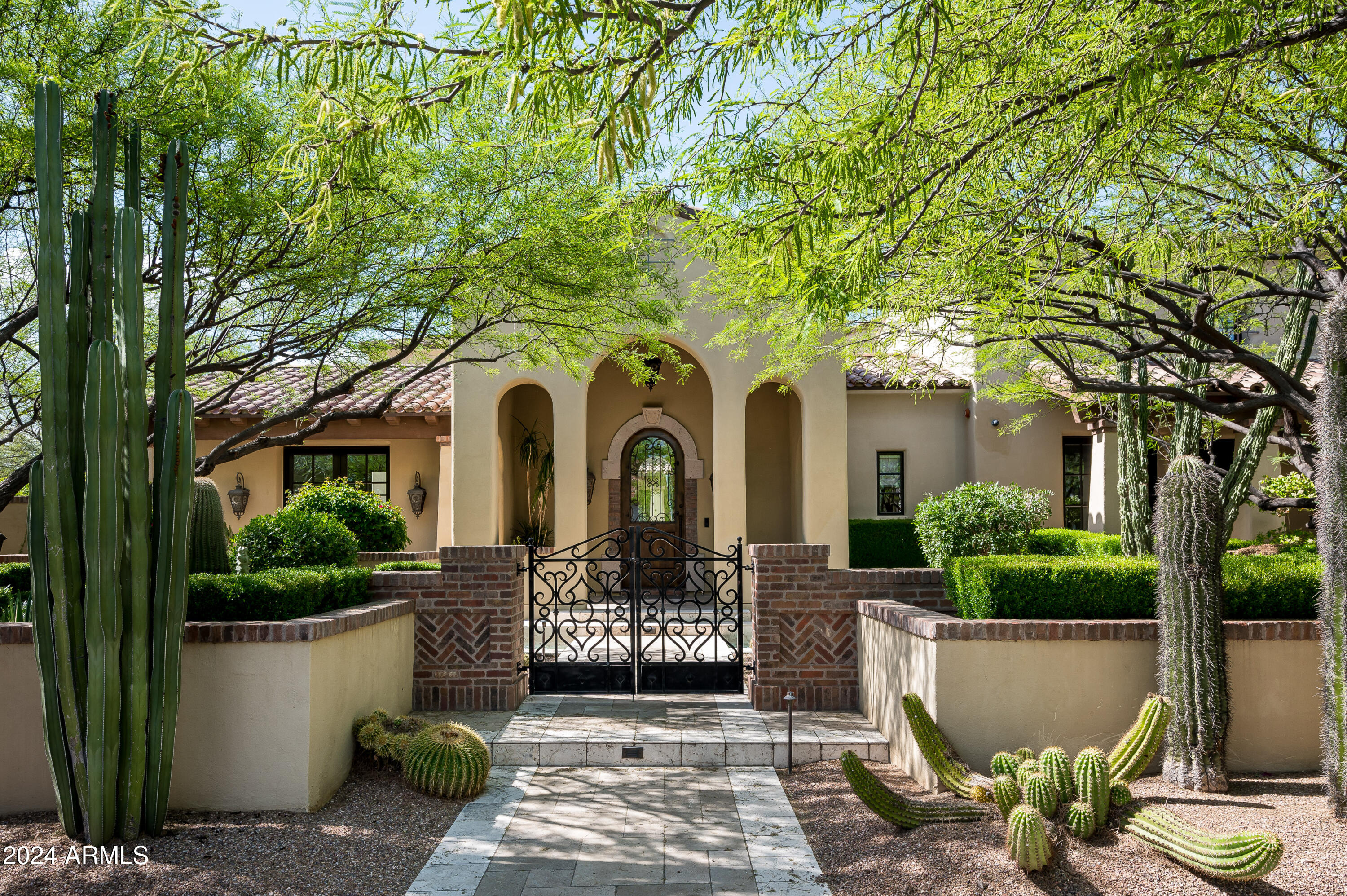 This 6,841-square-foot home in the desirable Windgate Pass neighborhood of Silverleaf combines elegant design with functional living. The residence includes 5 bedrooms, 5.5 bathrooms, and a thoughtful layout featuring a spacious dining room with access to the covered patio, a custom office, and a guest casita for added convenience. This home showcases quality craftsmanship with stone and wood floors, high ceilings with exposed beams, and a custom fireplace in the great room, creating a welcoming atmosphere. Practical touches like custom cabinetry and a wet bar further enhance its appeal. The well-appointed kitchen is equipped with high-end appliances, dual dishwashers, and a stylish wine wall, while the adjacent breakfast room enjoys plenty of natural light and peaceful views. The primary suite on the main level offers a comfortable retreat with a sitting or exercise area and a spa-like bathroom.
The guest casita provides privacy for visitors, while a flexible space and a second-level patio with views of the mountains and city lights offer versatile options for work or leisure.
Outside, the backyard features a pool, spa, outdoor fireplace, barbecue area, and a grassy play space, perfect for enjoying the Arizona climate. The home also includes a 3-car garage and is located in one of Scottsdale's most sought-after communities.
Situated in the Silverleaf community, residents enjoy access to exceptional amenities, including tree-lined streets, private parks, and the renowned Silverleaf Club, which offers a golf course, clubhouse, spa, and more for a luxury resort lifestyle.