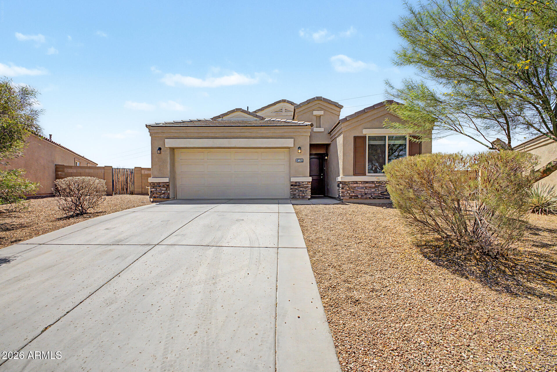 Beautifully maintained and move-in ready, this exceptional home offers a rare opportunity to own one of the larger lots in the highly sought-after Tartesso community! Situated on an oversized 10,414 sq.ft. lot (0.239 acres) with no neighbors behind, the property provides added privacy and ample space to create your dream backyard, add a pool, or simply enjoy the open space. Featuring a spacious 1,721 sq. ft. split floor plan, this home includes 4 bedrooms, 2 bathrooms, and a bright, open Great Room designed for modern living. The well-appointed kitchen showcases granite countertops, stainless steel appliances, a large pantry, and a center island with breakfast bar seating, making it ideal for both everyday living and entertaining. The private primary suite features an en-suite bath with dual vanities and a generous closet. Three additional bedrooms provide flexibility for family, guests, a home office, or hobbies.  Residents of Tartesso enjoy an outstanding community lifestyle with parks, splash pads, walking trails, and year-round neighborhood events, all with convenient access to the I-10 freeway for an easy commute.