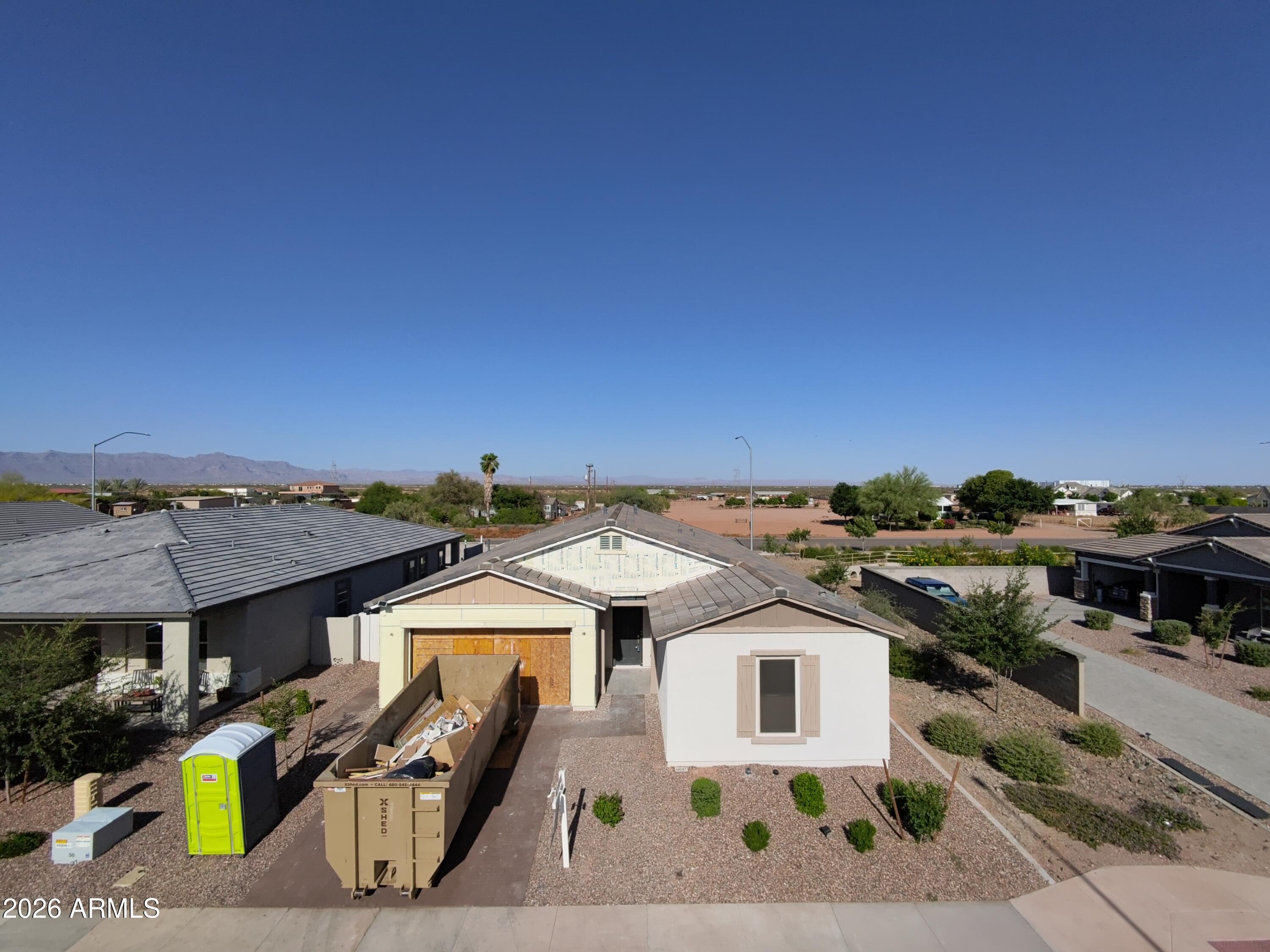 Welcome to a rare opportunity to personalize a nearly brand-new home in one of East Mesa's fastest-growing areas. This 4-bedroom, 3.5-bath home offers buyers the chance to create a custom feel without the extended timeline, uncertainty, or limitations of a traditional new build. Currently under reconstruction and rebuilt down to the studs, nearly every major component of the home is brand new, including the roof, insulation, drywall, HVAC system, water heater, and more. The attic has also been upgraded with foam insulation for enhanced energy efficiency and comfort beyond standard builder specifications. Unlike most builder spec homes where finishes have already been selected, this home gives buyers the unique opportunity to personalize many of the interior selections based on the current stage of construction. Buyer will have the ability to choose flooring, cabinetry, countertops, paint colors, lighting, accent walls, additional canned lighting, garage epoxy colors and finishes, and other custom design features to match their own style and vision.

Situated on a premium corner lot with only one direct neighbor and backing to a wash for added privacy, the location itself is hard to beat. The home also features a desirable 3-car tandem epoxy garage, permanent exterior lighting installed around the home, a soft water system, reverse osmosis system in the kitchen, and a backyard already designed for entertaining with low-maintenance turf, two pergolas, and an above-ground hot tub, saving buyers both time and significant post-move-in expenses.

This rapidly growing East Mesa corridor continues to attract attention for its convenience and future development. Located just minutes from the Loop 202, US-60, and SR-24, the home offers easy access throughout the Valley while remaining close to highly rated schools, parks, dining, and everyday amenities. Just a few miles away is the Arizona Athletic Grounds sports and entertainment complex, with additional major retail, luxury restaurants, hotels, shopping, and entertainment developments already planned nearby, making this an exciting opportunity to invest in an area with tremendous future growth

Additional bonus: seller currently has an assumable VA loan at 4.99%, creating a valuable financing opportunity for qualified buyers.