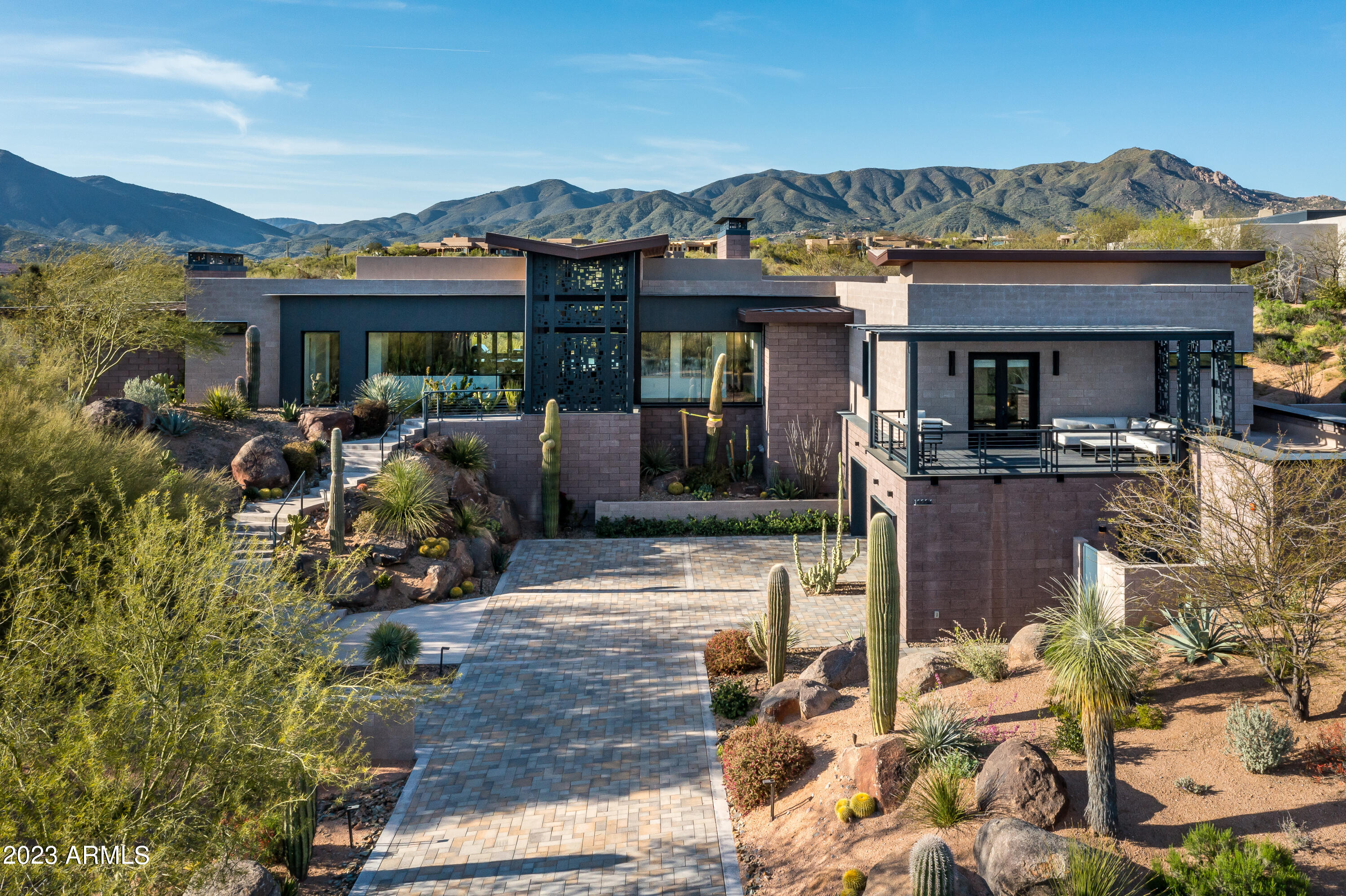 This stunning, architectural gem, designed by National award winner  Wendall Picket, was built with the highest level of construction and  enhanced further by the superior finish level inside. The open concept floor plan boasts a dramatic reverse tongue & groove ceiling and steel beams. The kitchen is an entertainers dream with top of the line appliances, a large center island and a glass display wine closet. All bedrooms are en-suite & have their own outdoor space. Location is fabulous; on a cul-de-sac, backs to an expansive area of open space, multiple mountain views & walking distance to the Sonoran Club. The resort backyard features a  salt water pool with a Baja shelf, a built in BBQ , wine fridge and a fire pit. Fully furnished with your choice of a golf or social membership.