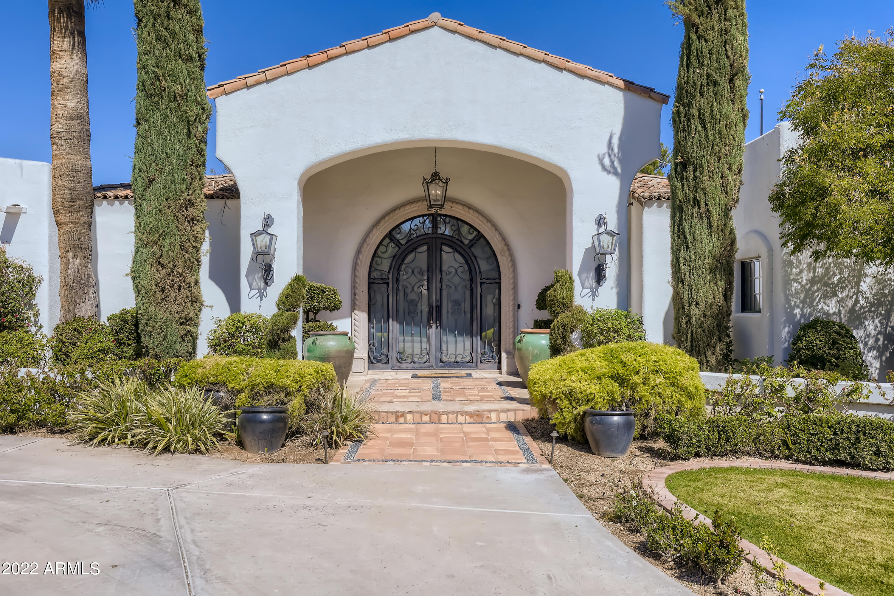 Views of the golf course and mountains from the moment you walk in the front door, soaring ceilings and huge windows add to the drama. This custom Santa Barbara style home was recently updated very tastefully - not a flip, the owners custom remodeled for themselves. Every finish is on trend from the hardwood floors to the bathroom tiles. All 4 bedrooms are en-suite, and there is separation between bedrooms for maximum privacy. The kitchen is a Chef's dream with a huge island, top grade appliances, and plenty of room for a dining table (in addition to the full dining room). The backyard is a paradise with mature landscaping, a large pool, spa, and outdoor dining that takes full advantage of the views. Air-conditioned 3 car garage has loads of storage, and adjacent slab parking for toys.
