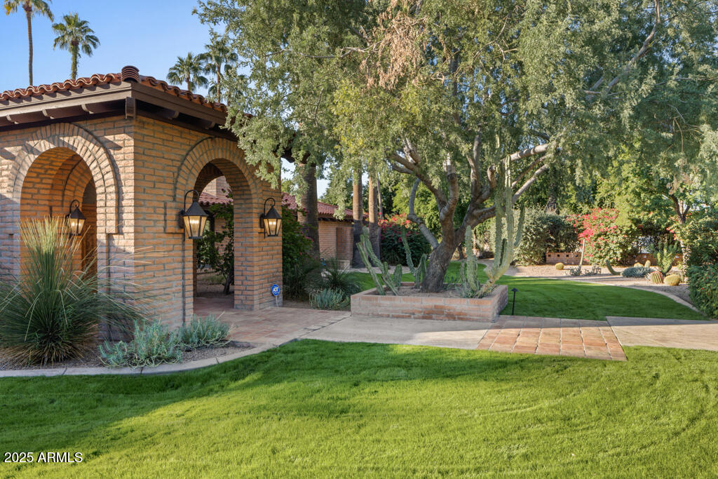 Set on an expansive three-quarter-acre lot in Arcadia Proper, this authentic Spanish Territorial estate blends rich architectural detail with refined modern upgrades. From the moment you enter, Saltillo tile floors, vaulted and beamed ceilings, and artisan Spanish tile accents set an atmosphere of warmth, craftsmanship, and character.
Thoughtfully designed for both daily living and gracious entertaining, the home offers 5
bedrooms plus a private office, 5.5 bathrooms, and an inviting casita with a separate entrance. Pella windows and exterior doors provide enhanced comfort and clarity while honoring the home's architectural roots. The chef's kitchen features premium Sub-Zero and Dacor appliances, elevating both function and form. Four fireplaces—located in the primary suite, family room, casita, and outdoor patiocreate intimate gathering spaces throughout the property. Step outside to an expansive backyard oasis with Camelback Mountain views, a large covered patio, built-in BBQ, and a sparkling pool & spa. Lush green lawns, mature landscaping, and raised garden beds complete the serene setting.
Additional features include an oversized 3-car garage with a separate workshop and abundant storage. With charm, scale, and modern enhancements rarely found together, this is a signature
Arcadia property ready to be enjoyed for years to come.