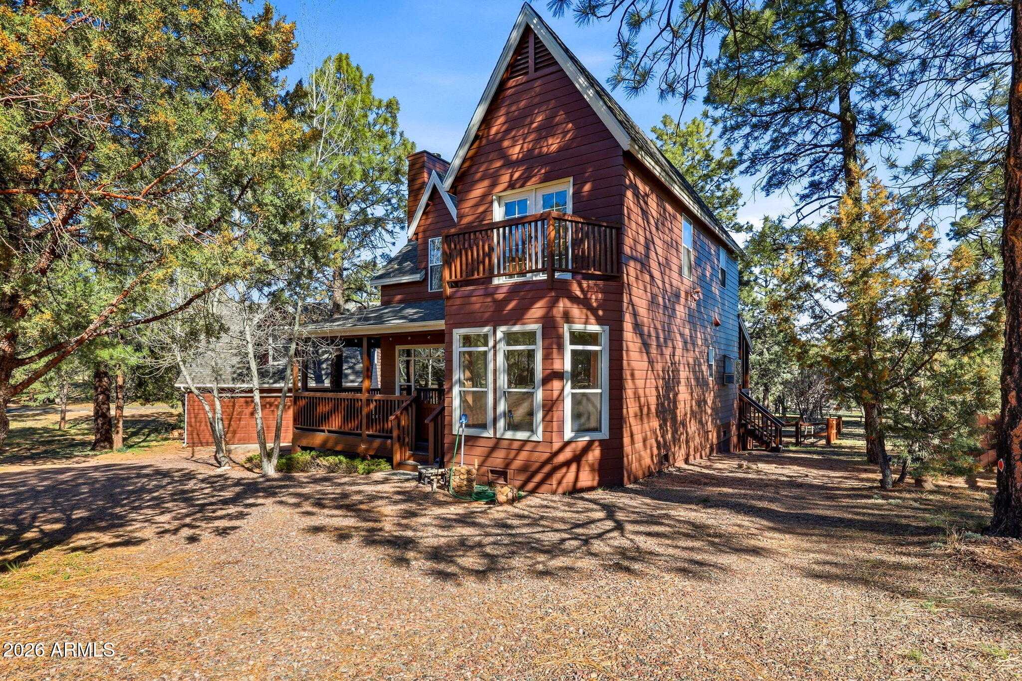 Charming mountain home nestled among the tall pines in the desirable Forest Trails area of Overgaard. Situated on a beautifully treed oversized lot of nearly 3/4 acre, this 3 bedroom, 2 and a half bathroom home also includes a versatile den. The spacious living room features a cozy wood-burning fireplace, perfect for cool mountain evenings. Enjoy the outdoors from the wrap-around covered deck overlooking the peaceful yard and garden area. The property also includes a detached two-car garage with a loft/den above, ideal for a hobby room, office, or extra storage. Perfect as a full-time home, vacation getaway, or investment property in Arizona's White Mountains.